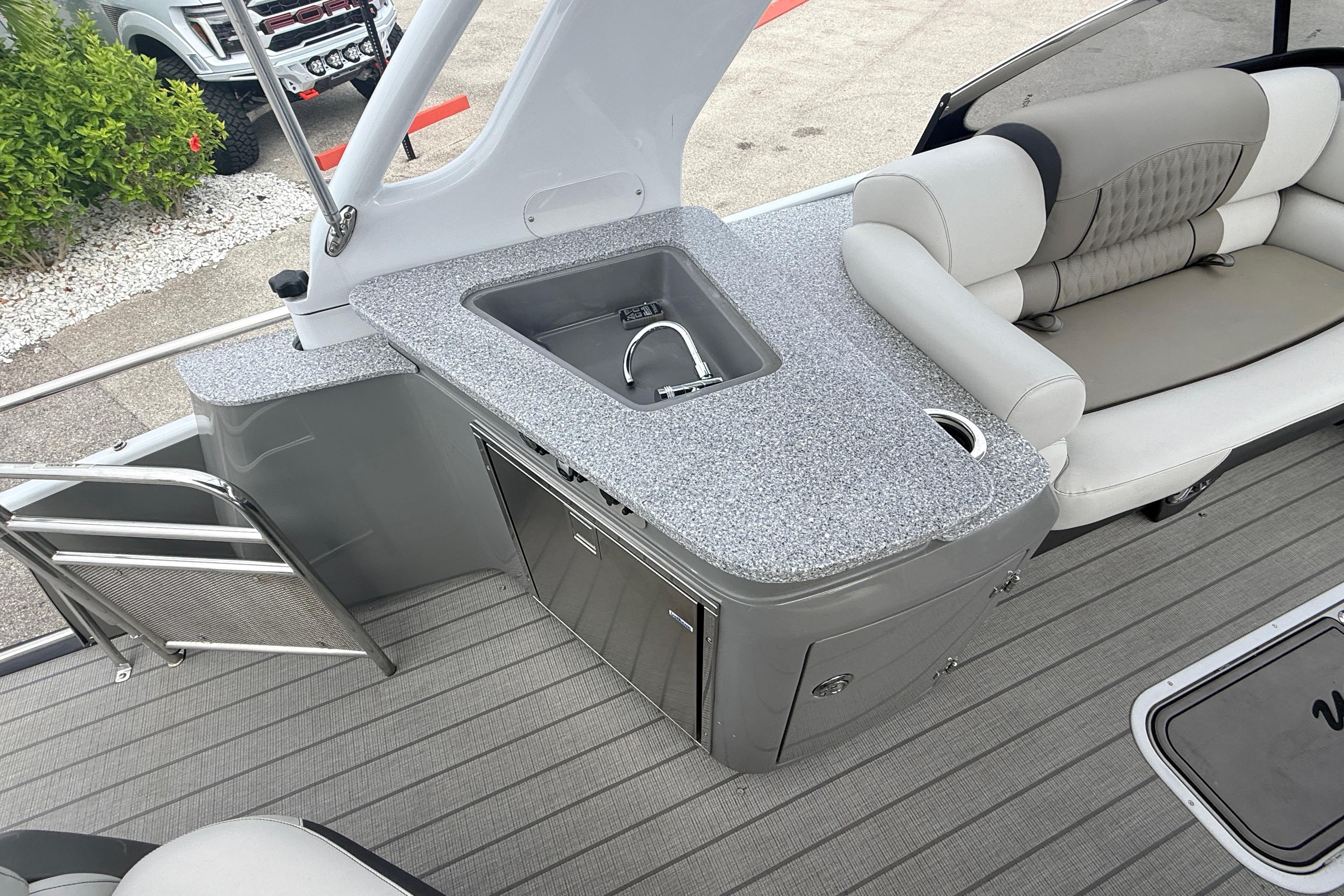 2023 Avalon Excalibur 2585 boat interior with sleek seating and modern kitchenette.