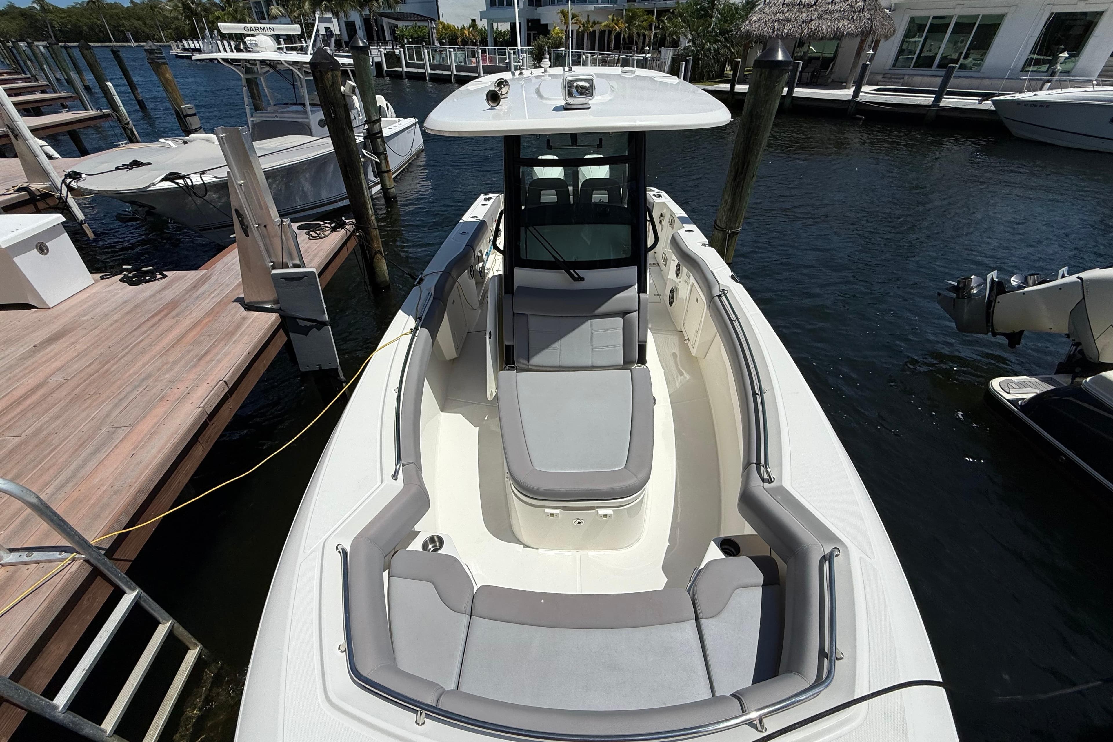 2024 Boston Whaler 280 Outrage docked, showcasing spacious seating and sleek design.