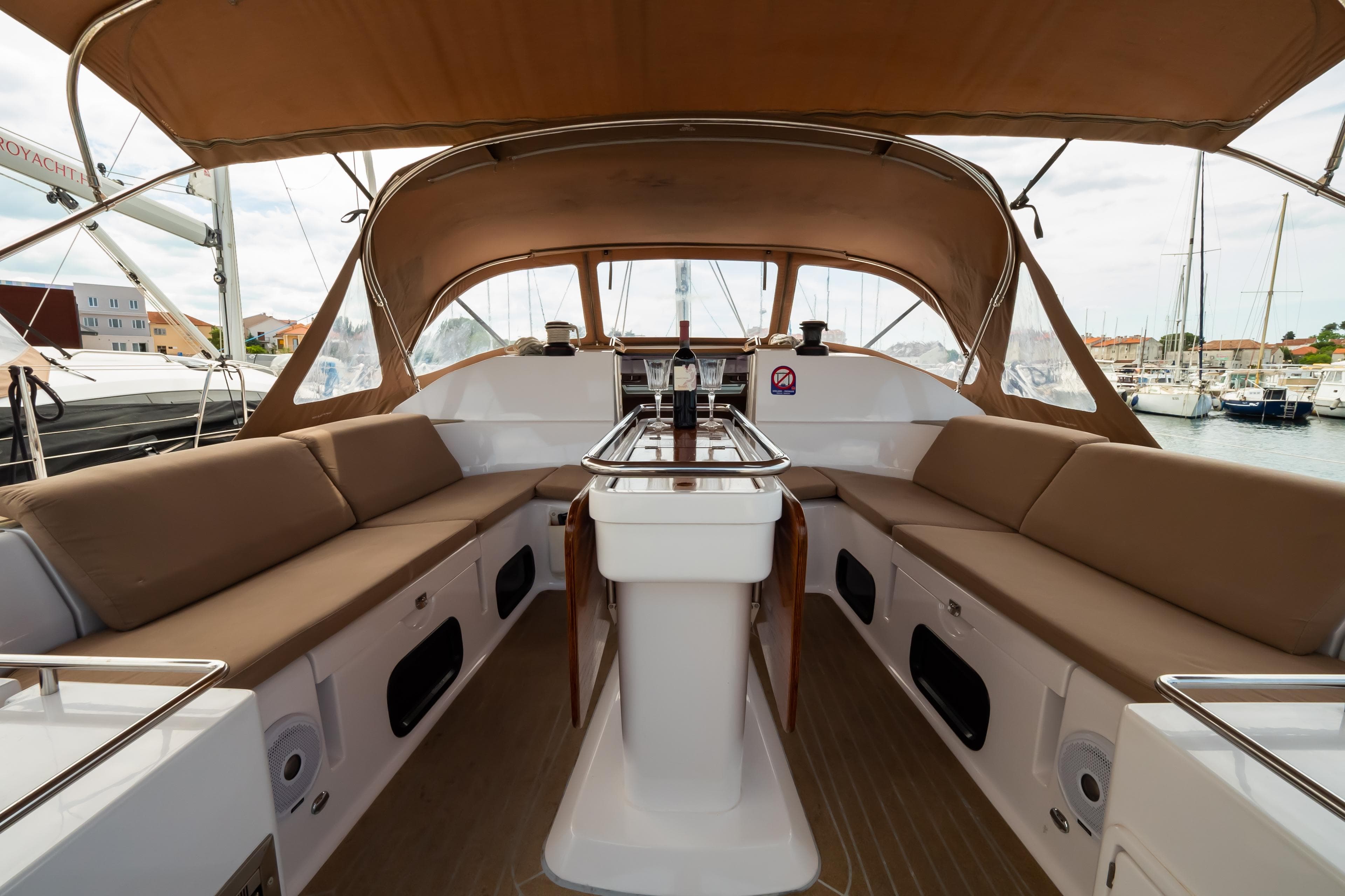 Spacious cockpit of 2018 Elan Impression 50 yacht with beige seating and canopy.