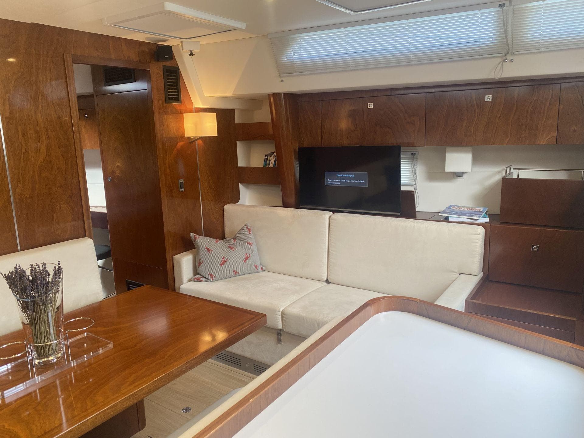 Interior of a 2015 Amel 55 yacht with elegant wood finish.