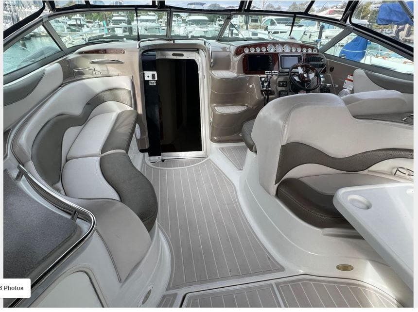 Interior of a 2004 Larson 370 boat with plush seating and modern dashboard.