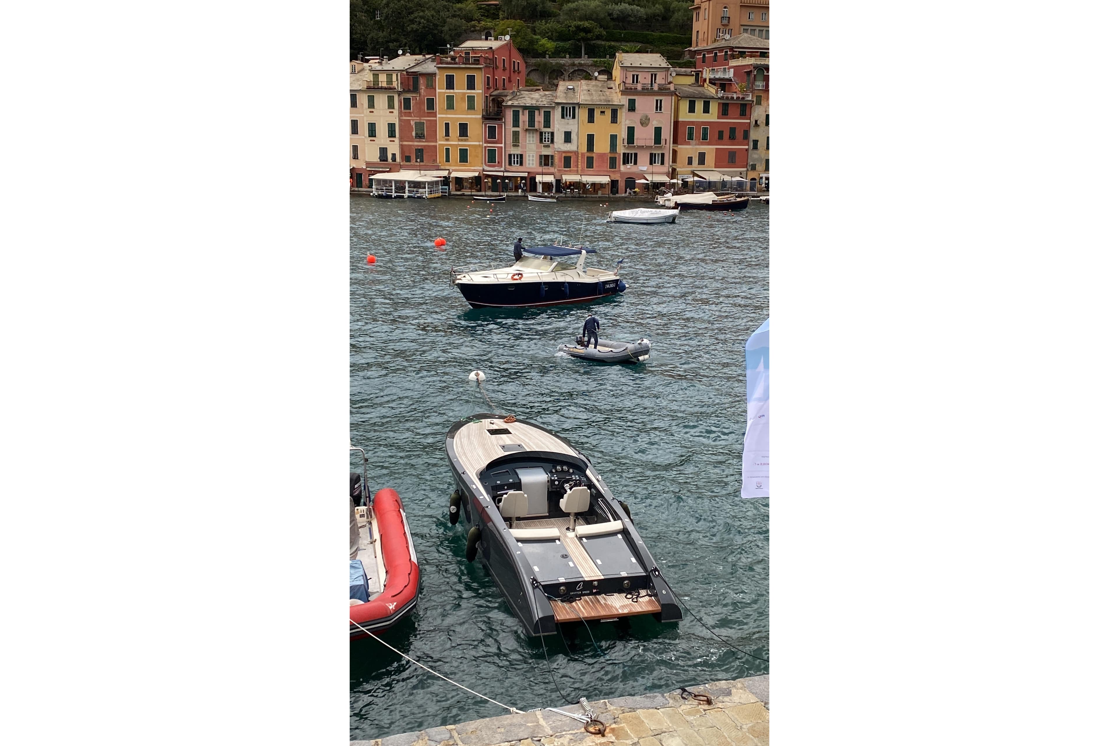 2019 Frauscher GT 1017 boat docked in scenic harbor with colorful buildings.