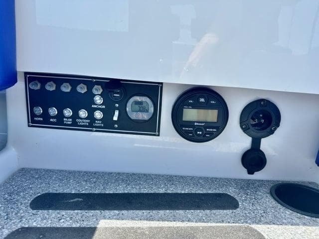 Control panel of 2023 Vision Marine Technologies Fantail 217 boat with switches and gauges.
