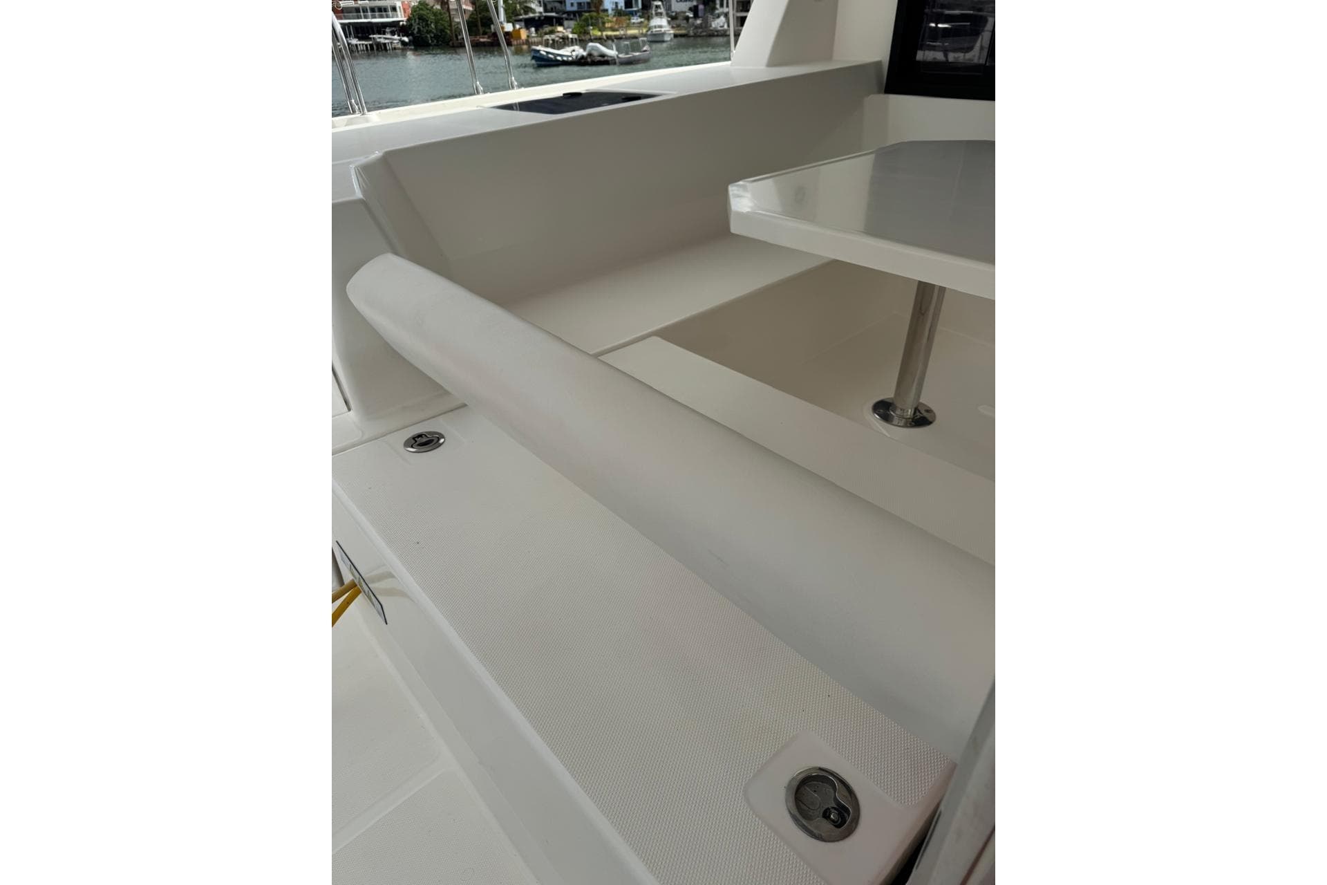 Leopard 45 yacht interior seating and table, 2017 model, with marina view.