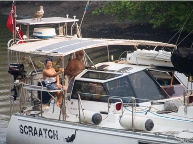 A Sundeer 56 yacht named "Scraatch" with two people on deck, 1994 model.