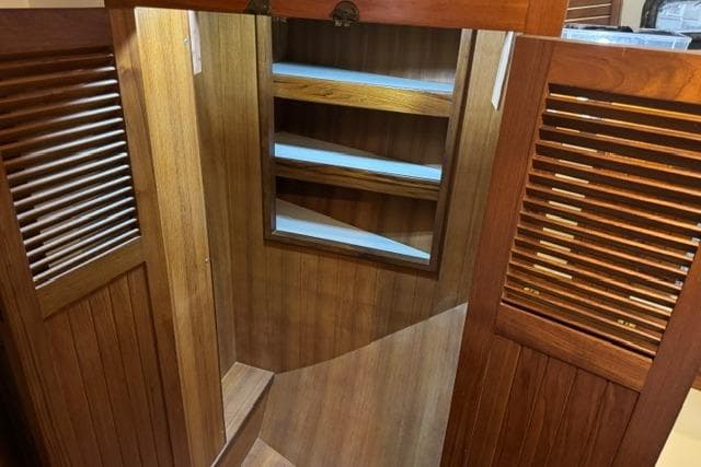 Wooden interior shelving in a 1986 Kadey-Krogen 42 yacht.