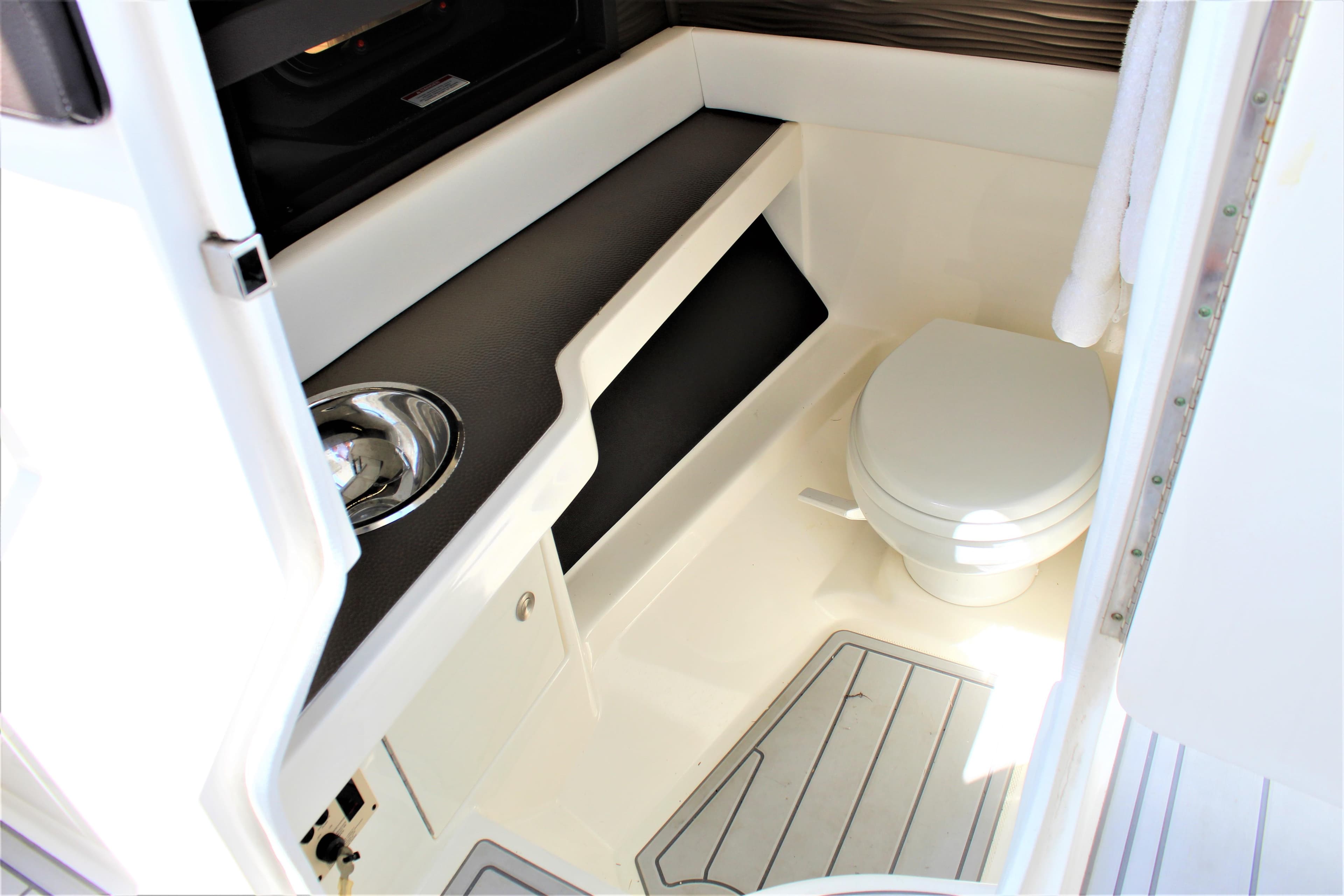 Interior of 2017 Sea Ray SLX 310 featuring toilet and sink.