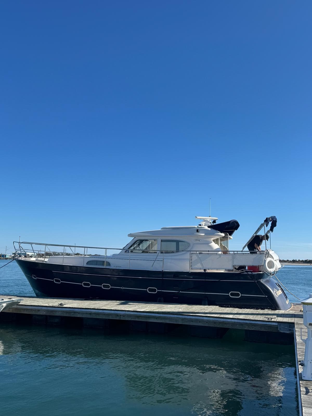 Elling E3 2007 yacht docked on calm water under clear blue sky.