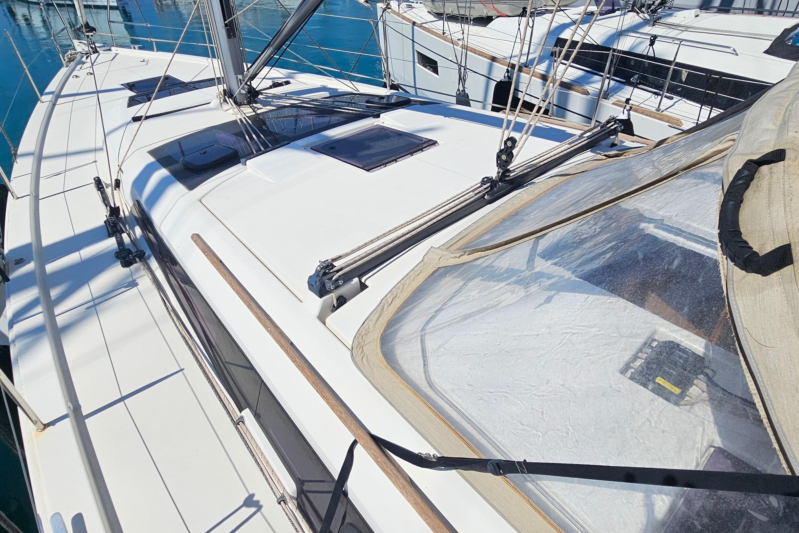 2020 Dufour 390 sailboat deck with rigging and clear canopy in marina.