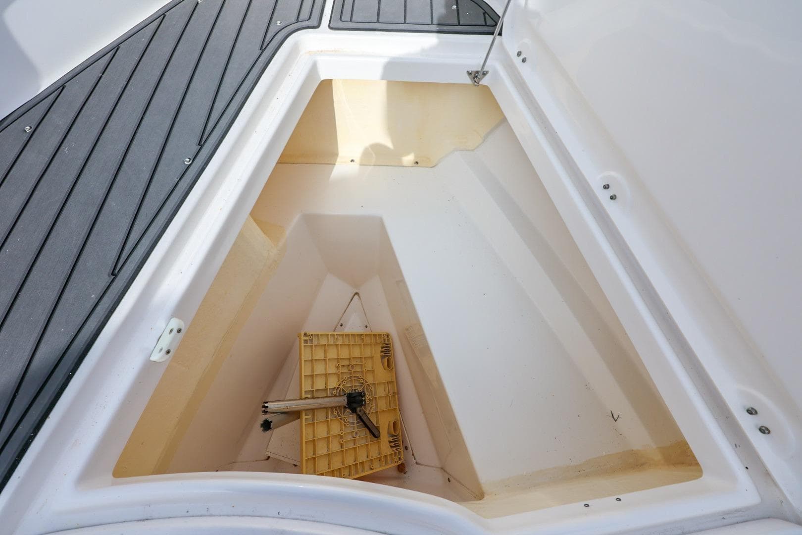 Storage compartment of 2017 Everglades 355 Center Console boat, featuring a clean interior.
