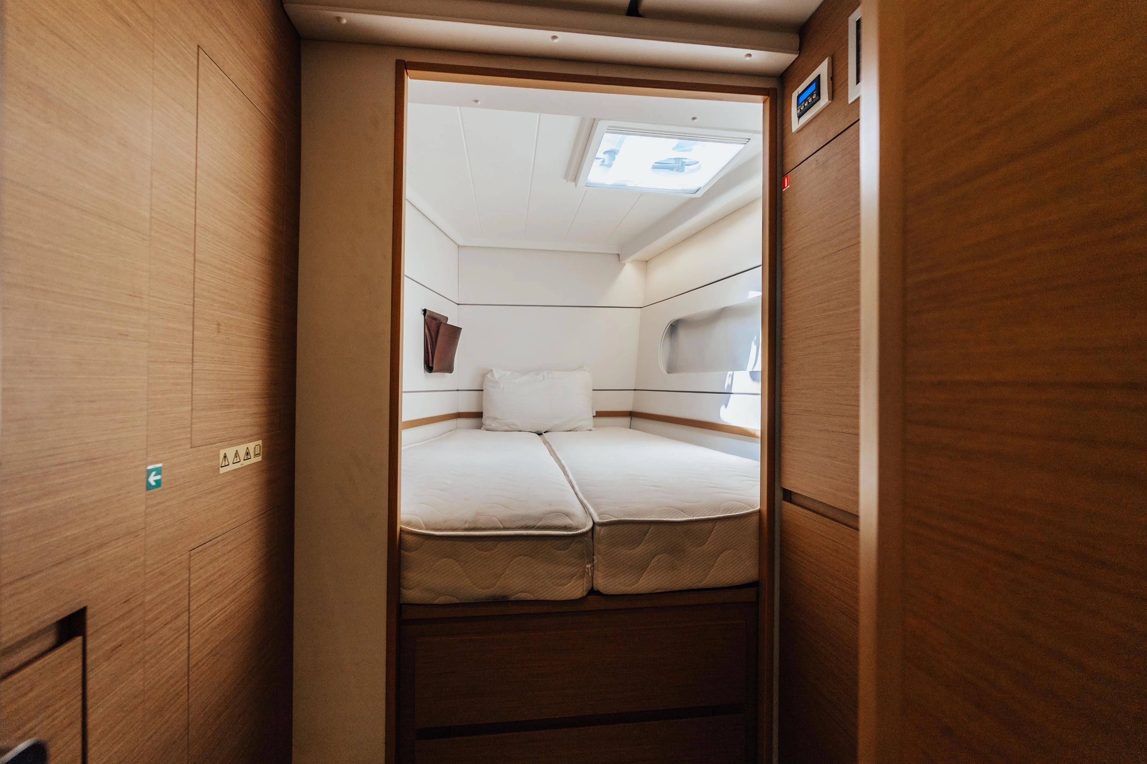 Interior of Excess 12 yacht, bedroom with bed and window.