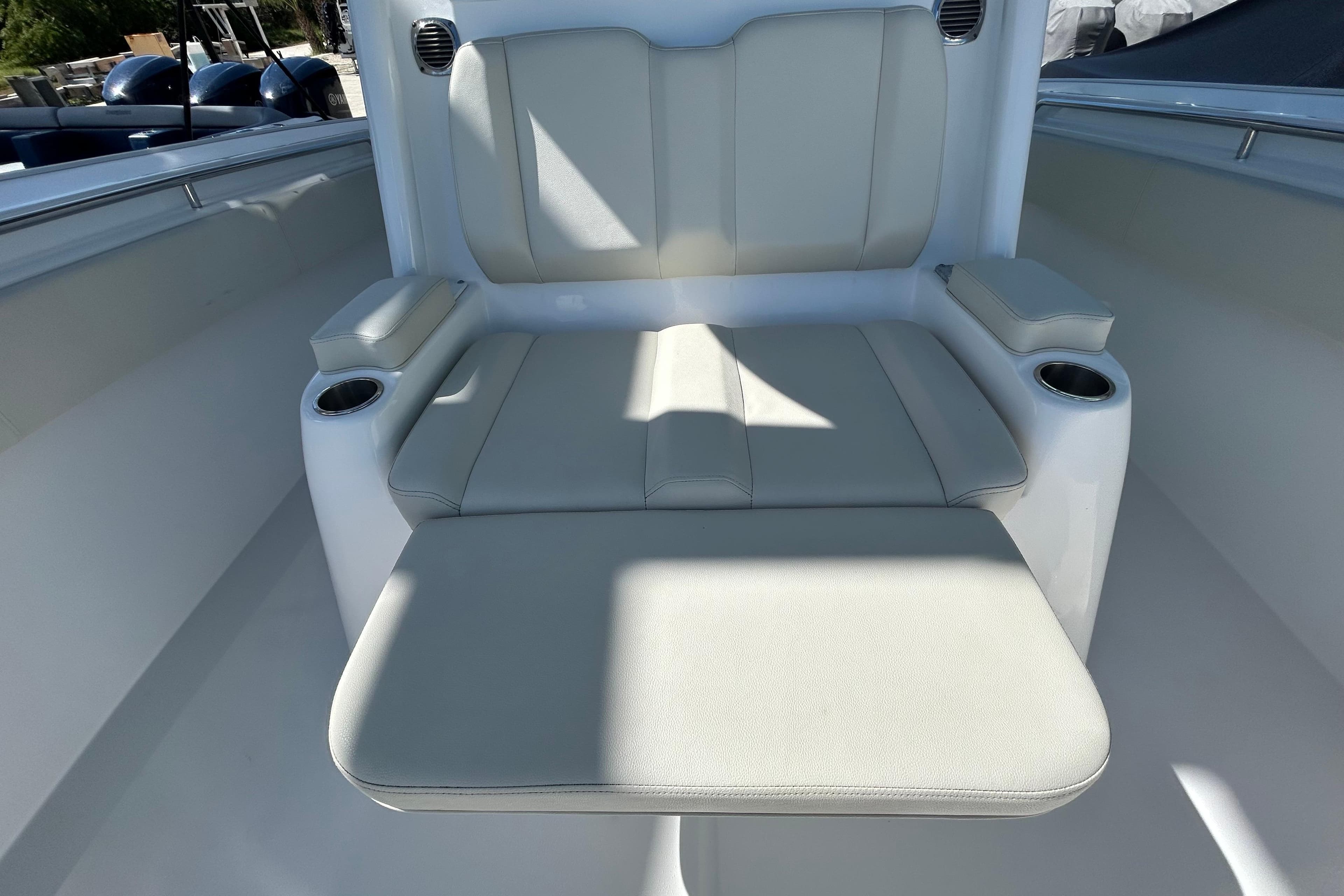 Luxurious seating on 2022 Cape Horn 36 boat with cup holders and armrests.