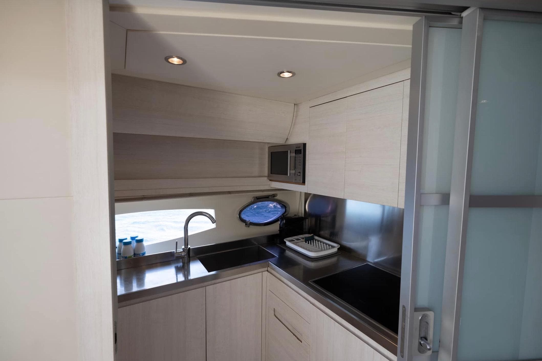 Modern kitchen interior of 2006 Pershing 56 yacht with sleek design and stainless steel appliances.