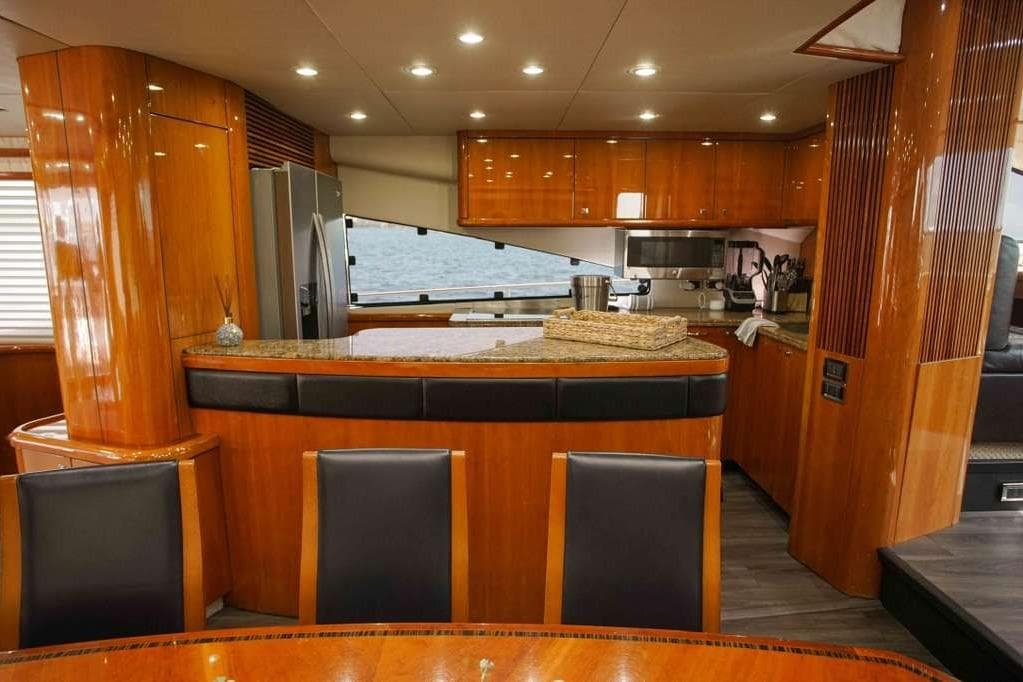 Luxurious kitchen interior of 2006 Sunseeker Manhattan Motor 82 yacht with wood finish.