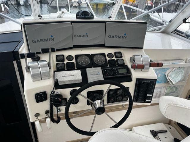 1996 Albemarle 305 boat helm with Garmin navigation displays and controls.