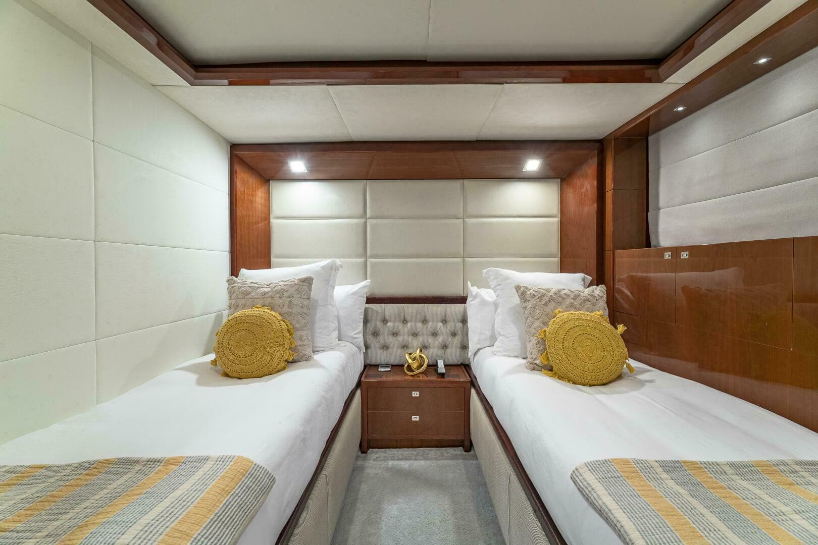 Luxurious twin cabin interior of 2012 Princess 32M yacht with modern decor.