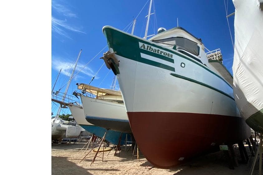 1979 Shrimper Conversion Trawler "Albatross" on dry dock under clear blue sky.