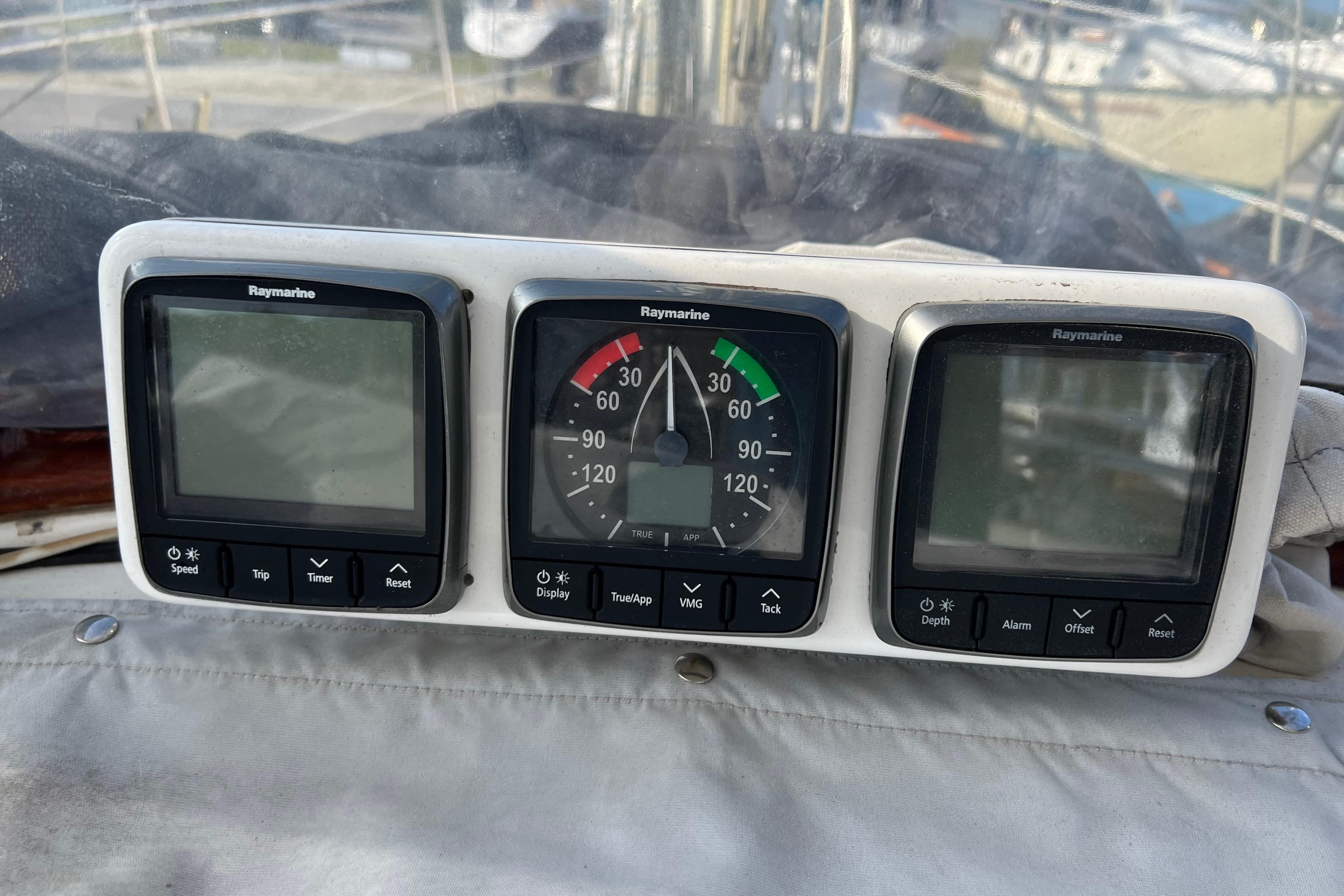 Raymarine instrument panel on a 1977 Gulfstar 43 sailboat, featuring speed, wind, and depth displays.