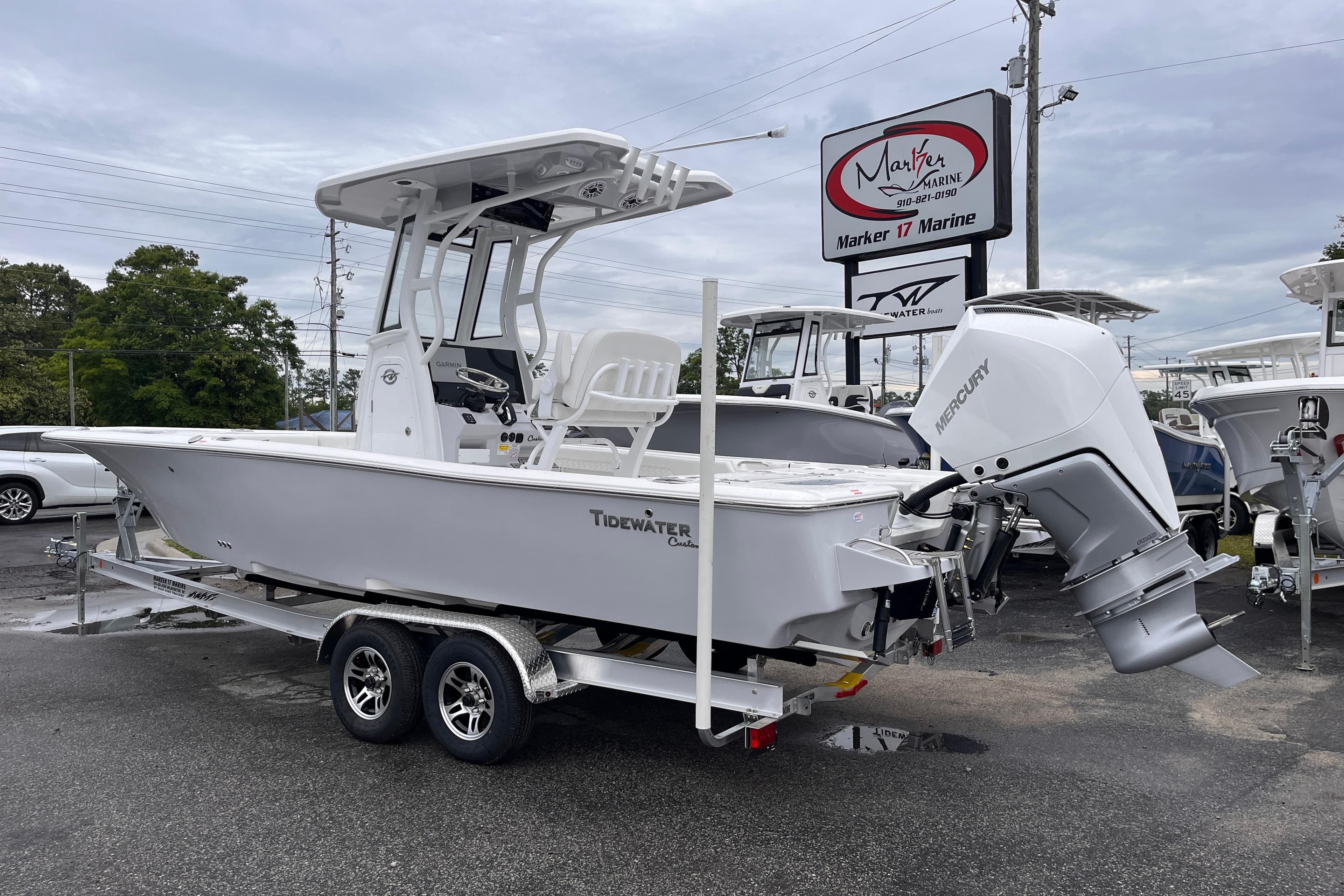 2026 Tidewater 2500 Carolina Bay boat on trailer at dealership, featuring Mercury outboard engine.