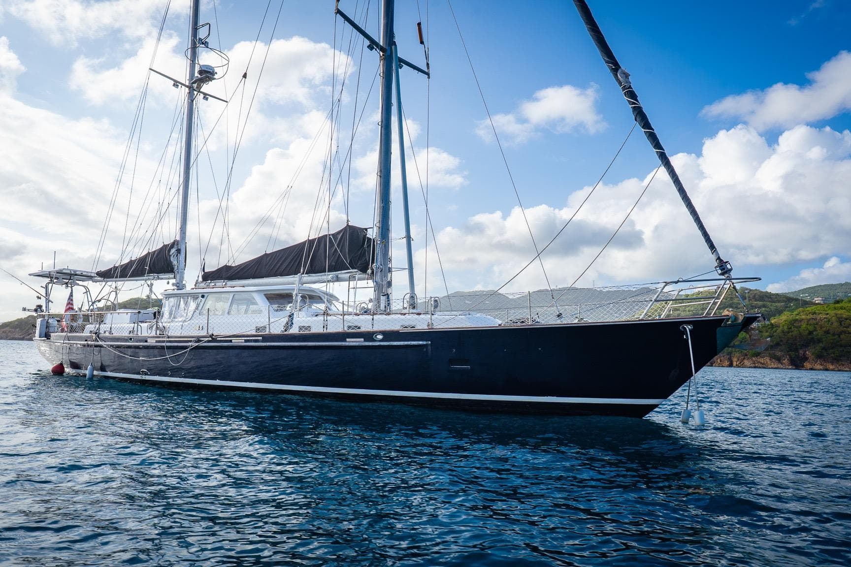 Sailing yacht "Alan Wright Custom 65" from 1973 on calm blue waters.