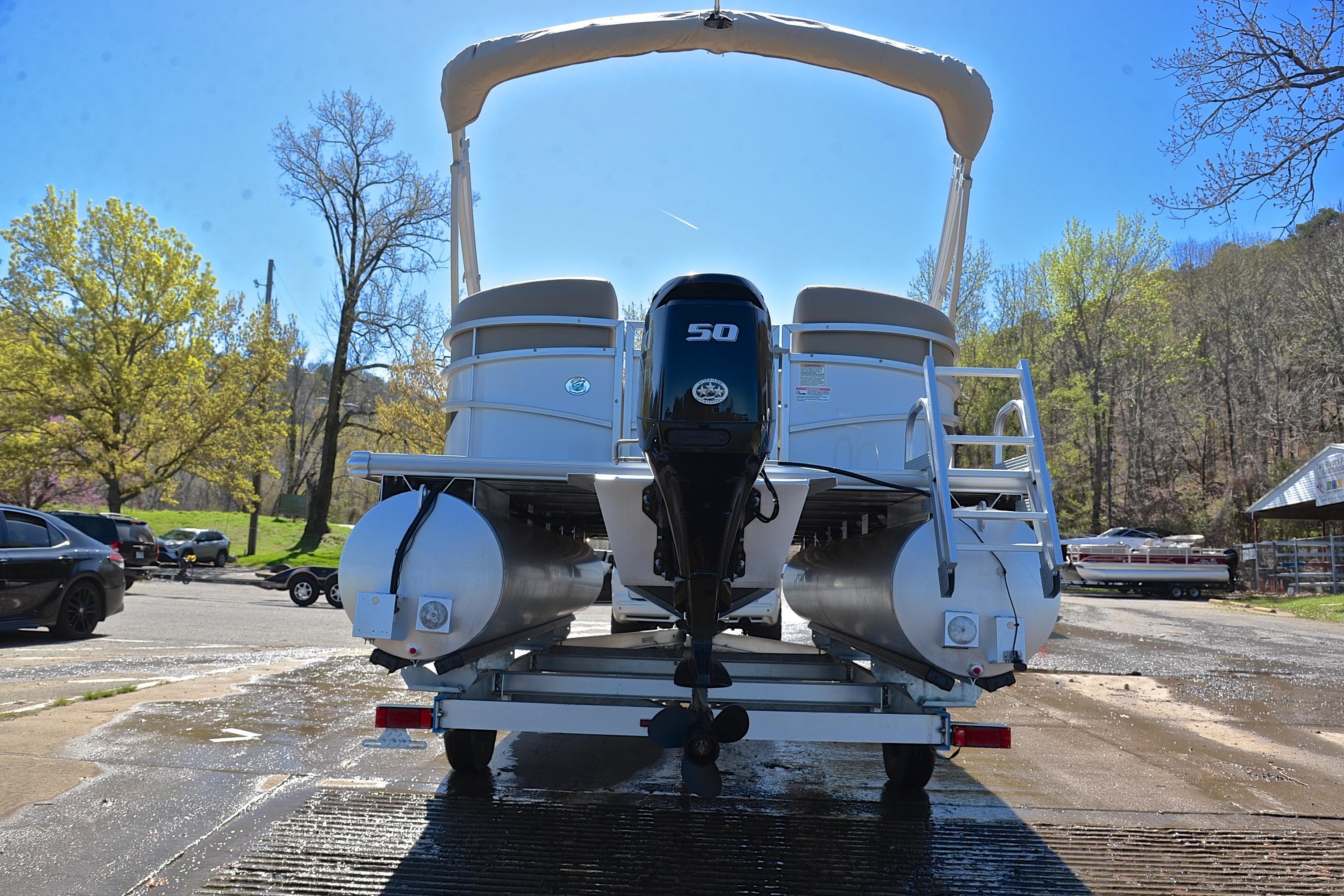 2023 Starcraft EX 18 F pontoon boat on trailer, rear view, outdoors.