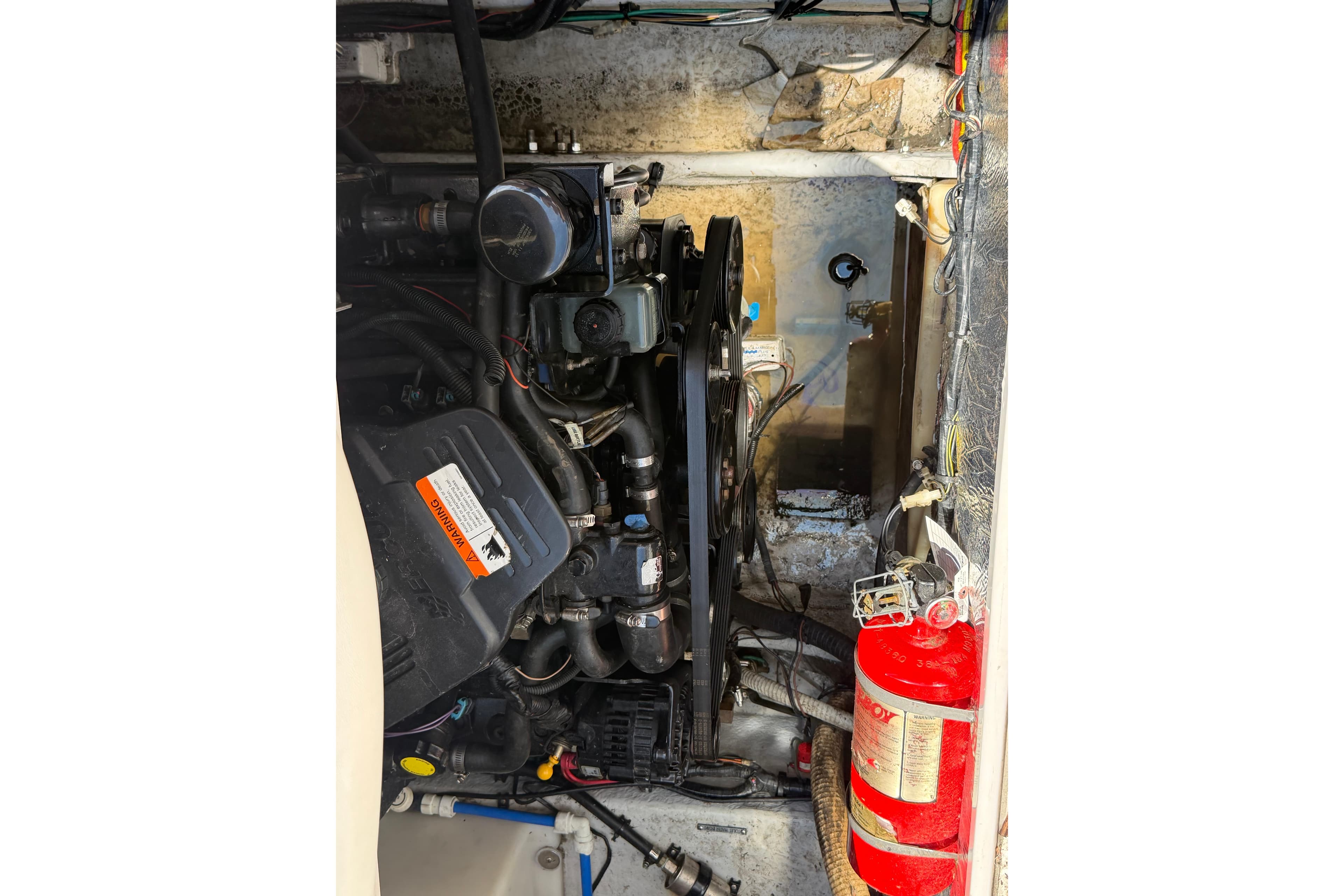 Engine compartment of a 2004 Four Winns 268 Vista boat with visible fire extinguisher.