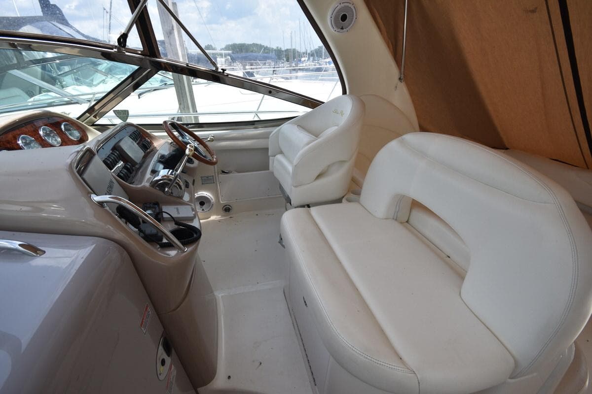 2003 Sea Ray 360 Sundancer cockpit with white seating and steering console.