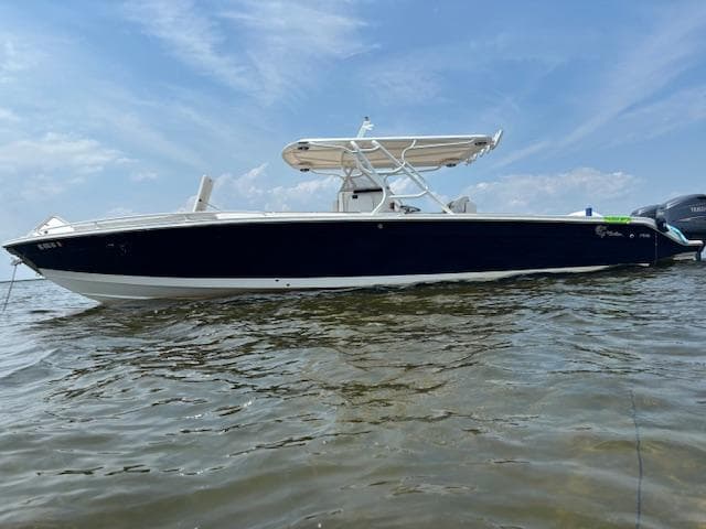 2004 Marlago FS35 boat on water under clear sky.