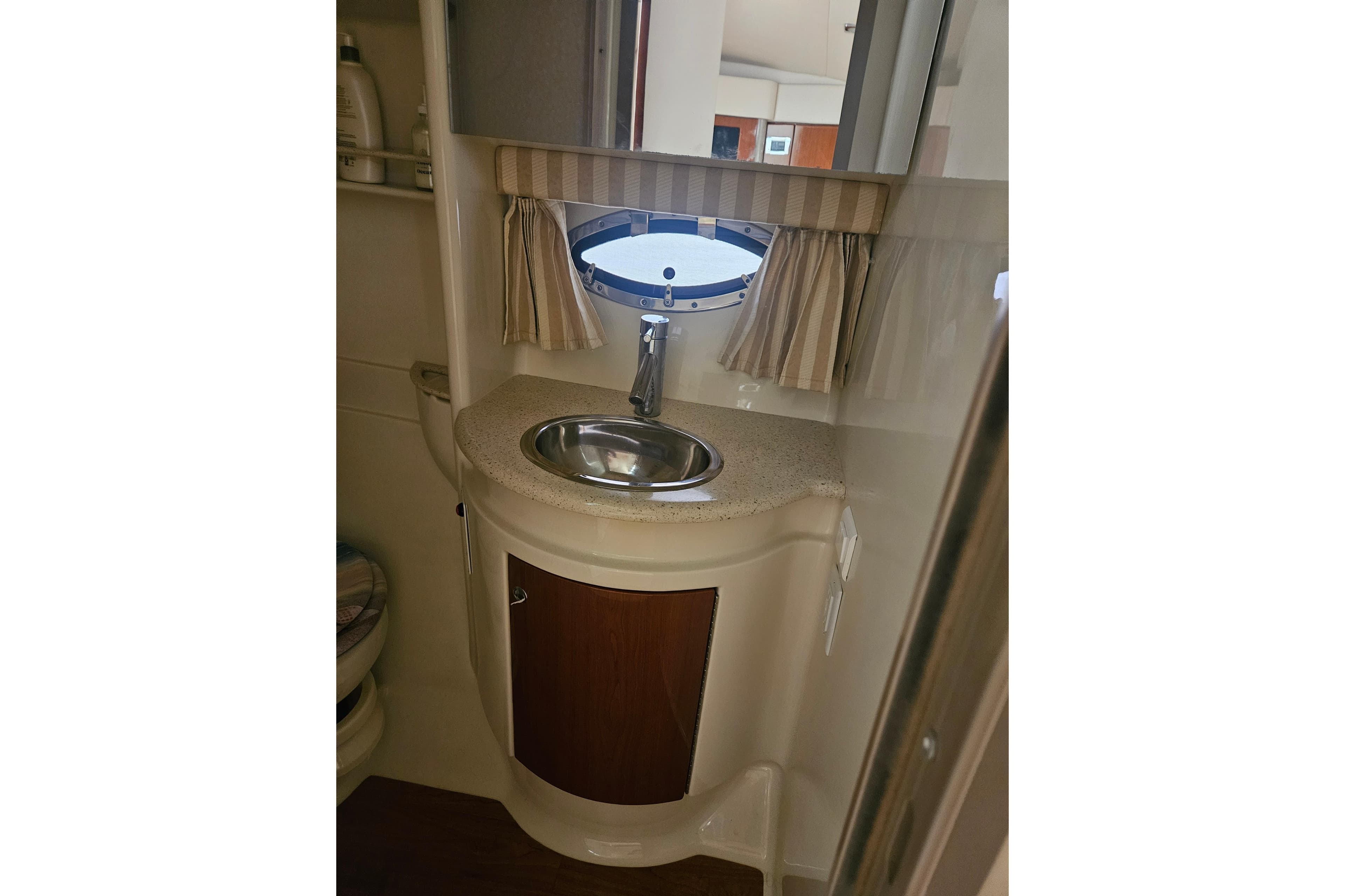 2010 Formula 34 Performance Cruiser bathroom with sink and porthole window.
