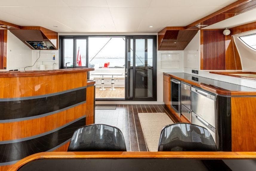 Luxurious interior of 2016 HH Catamarans HH66 with modern kitchen and elegant wood finishes.