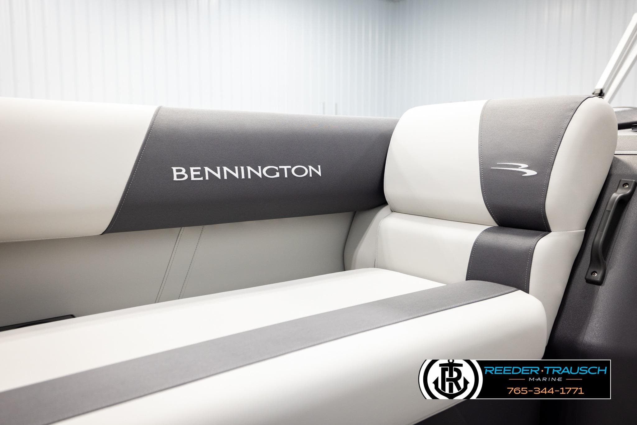 2026 Bennington SSBSF boat interior with branded seating, featuring sleek gray and white upholstery.