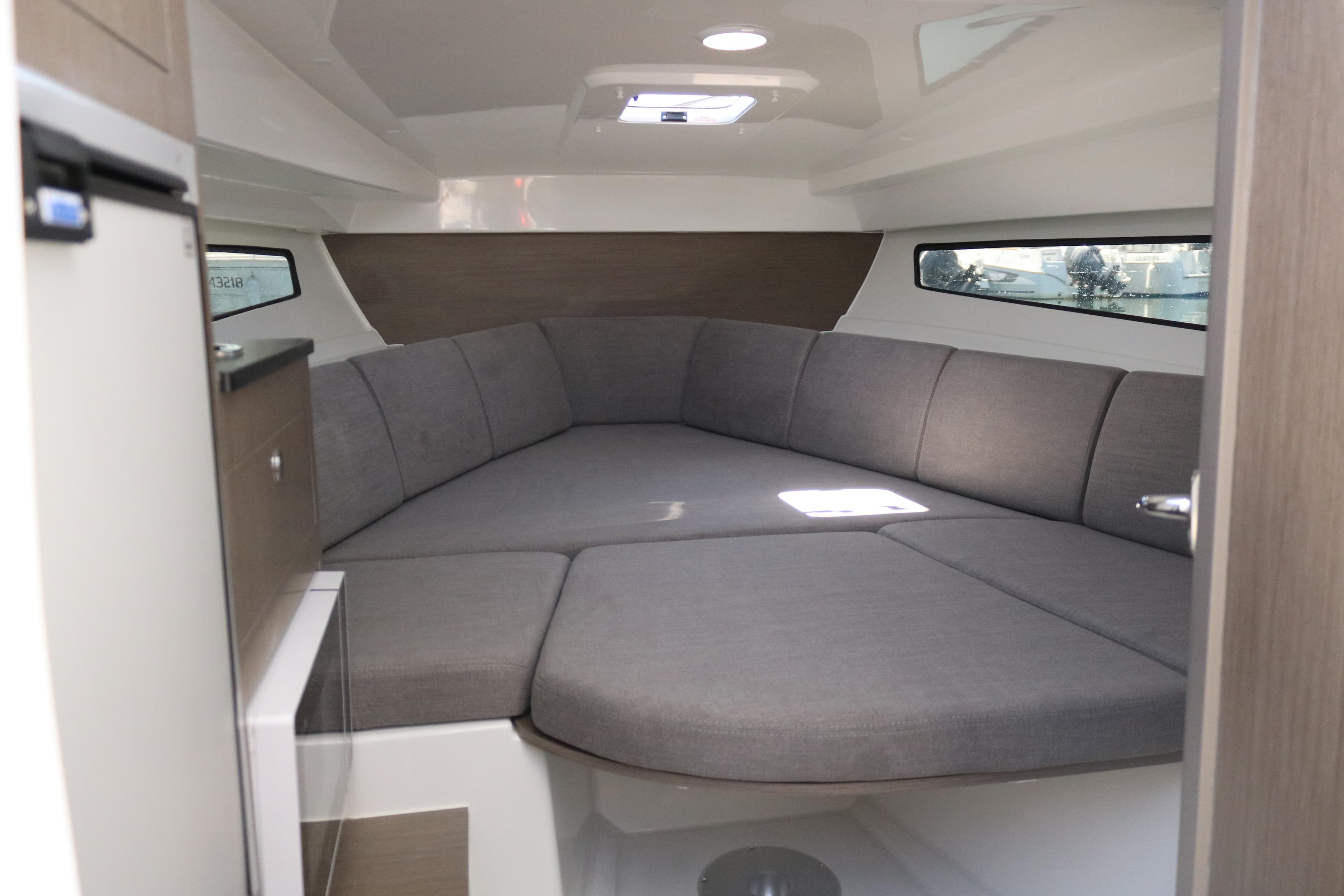 2023 Beneteau Flyer 8 SUNdeck cabin interior with modern seating and natural light.