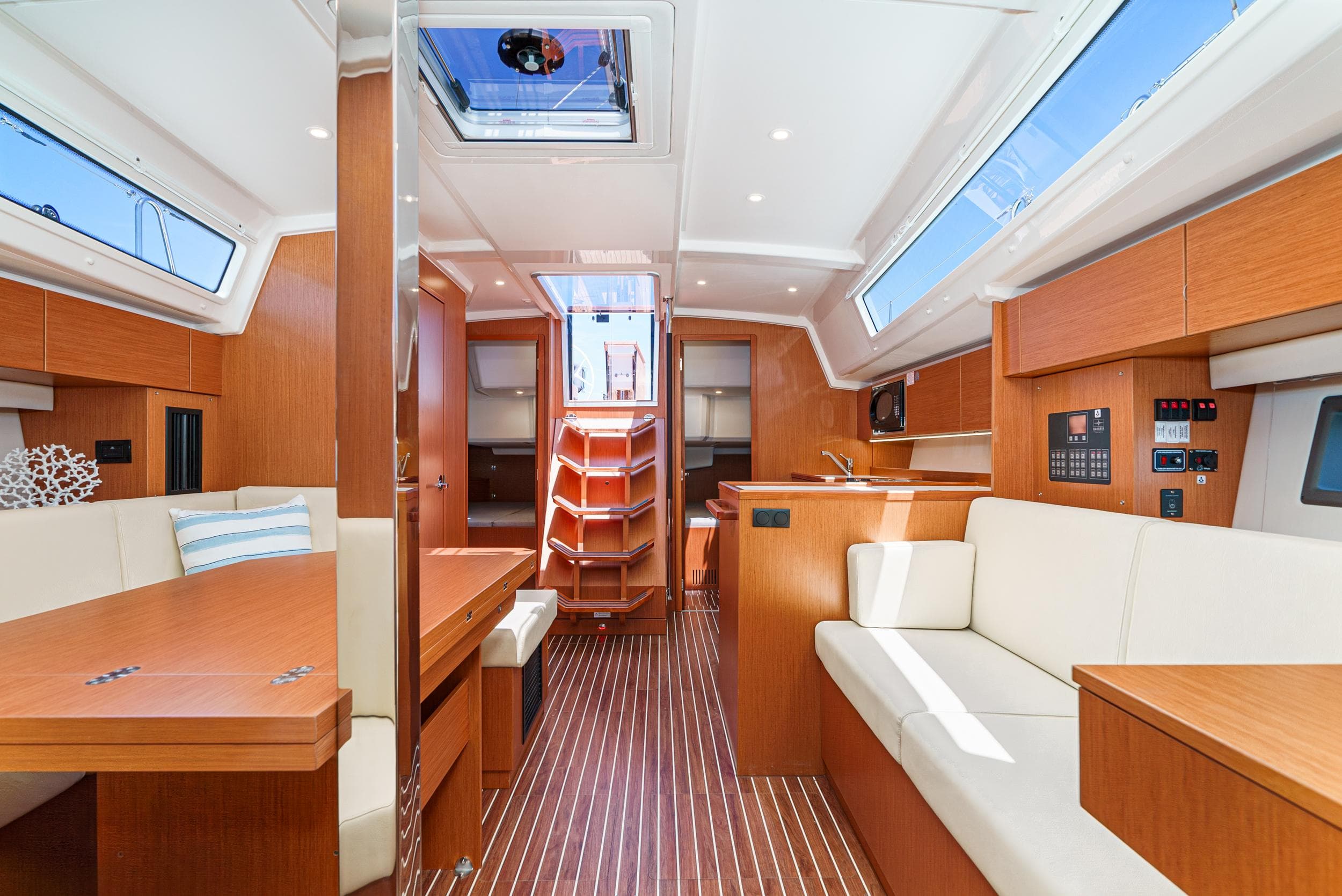 Luxurious interior of 2024 Bavaria C42 yacht, featuring modern wood finishes and spacious seating.