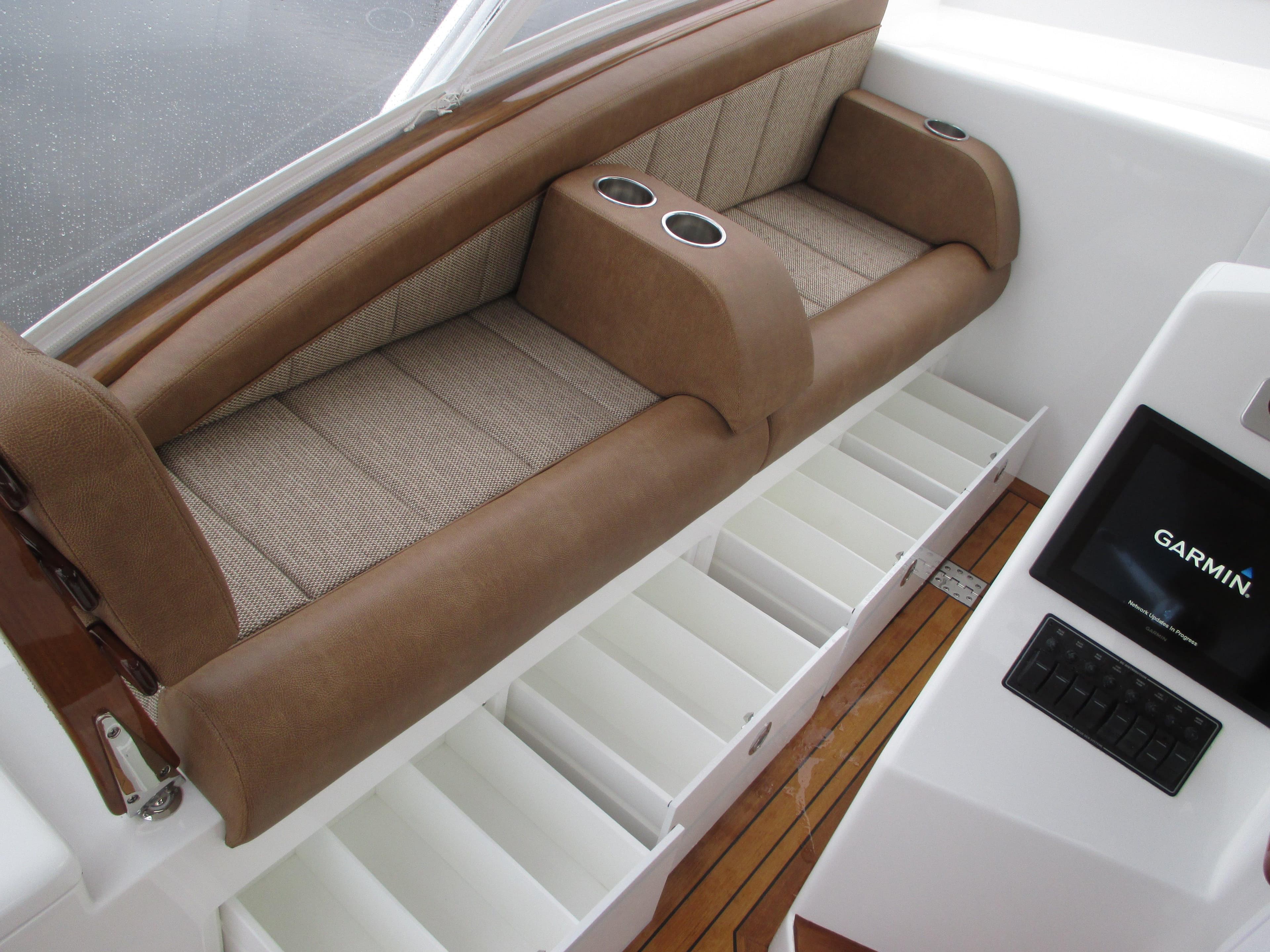 Jersey Cape Devil 36 Custom 2024 interior seating with storage compartments and Garmin display.