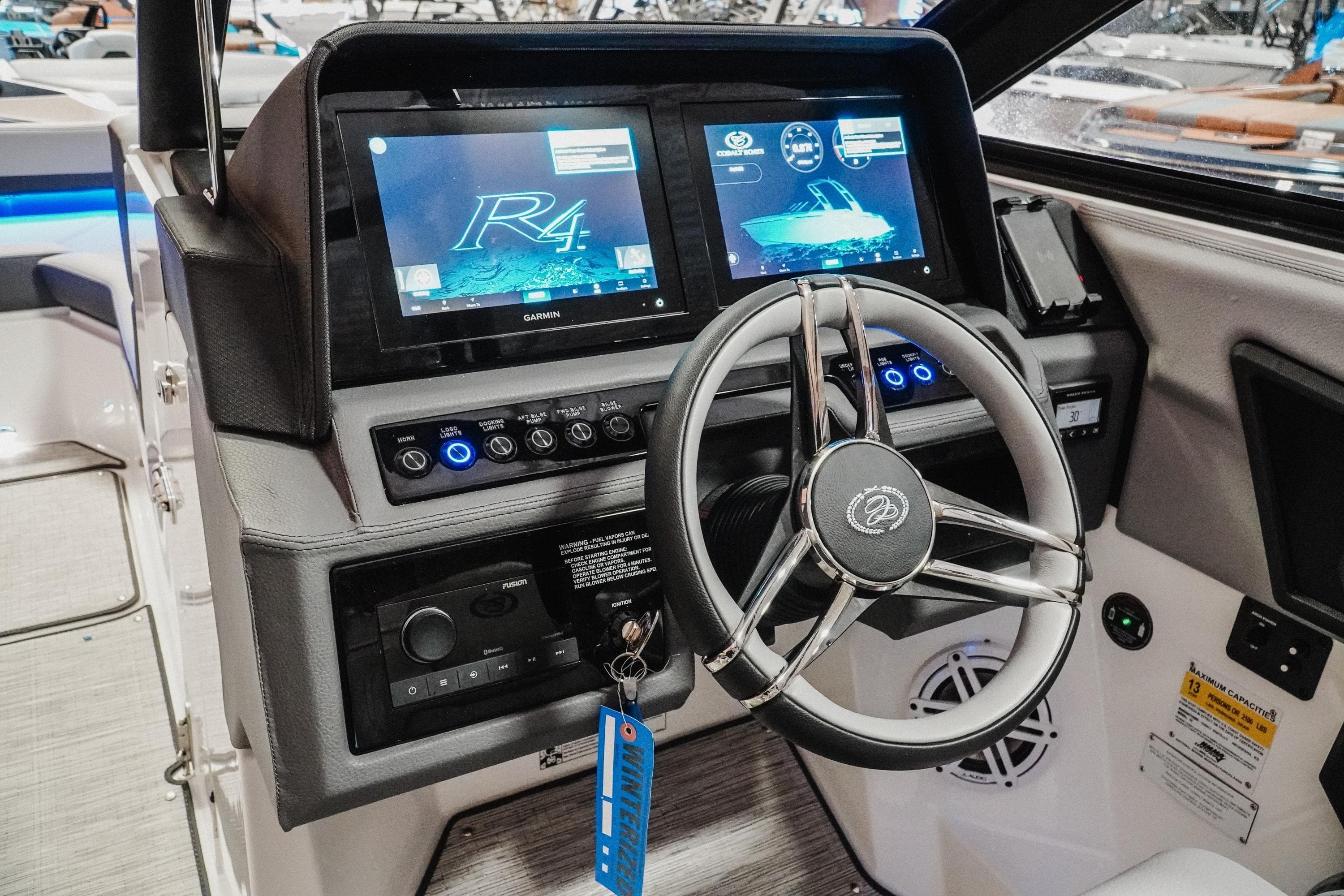 2026 Cobalt R4 boat dashboard with advanced navigation screens and sleek steering wheel.