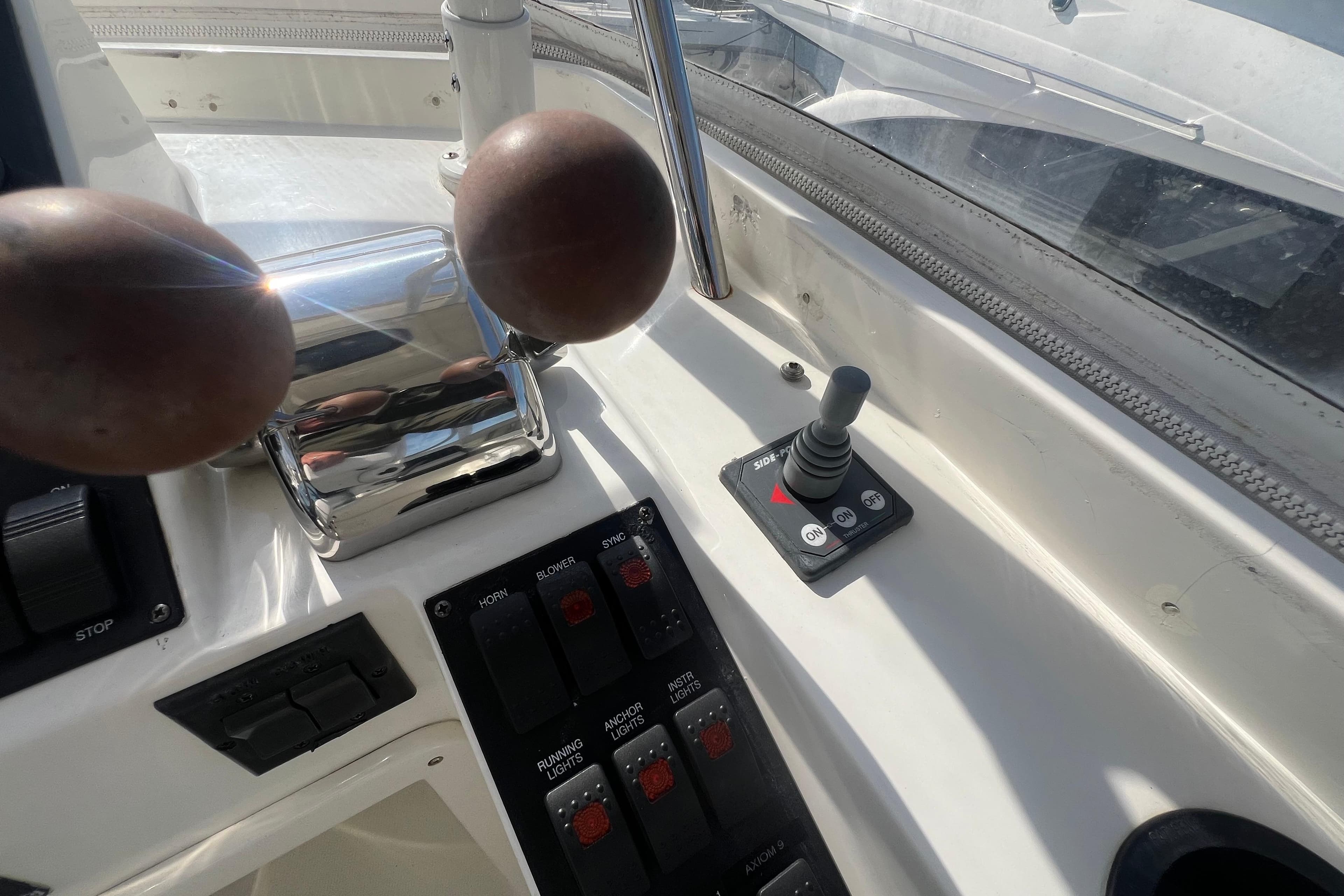 Control panel of a 2005 Sabre Flybridge boat with throttle and joystick.
