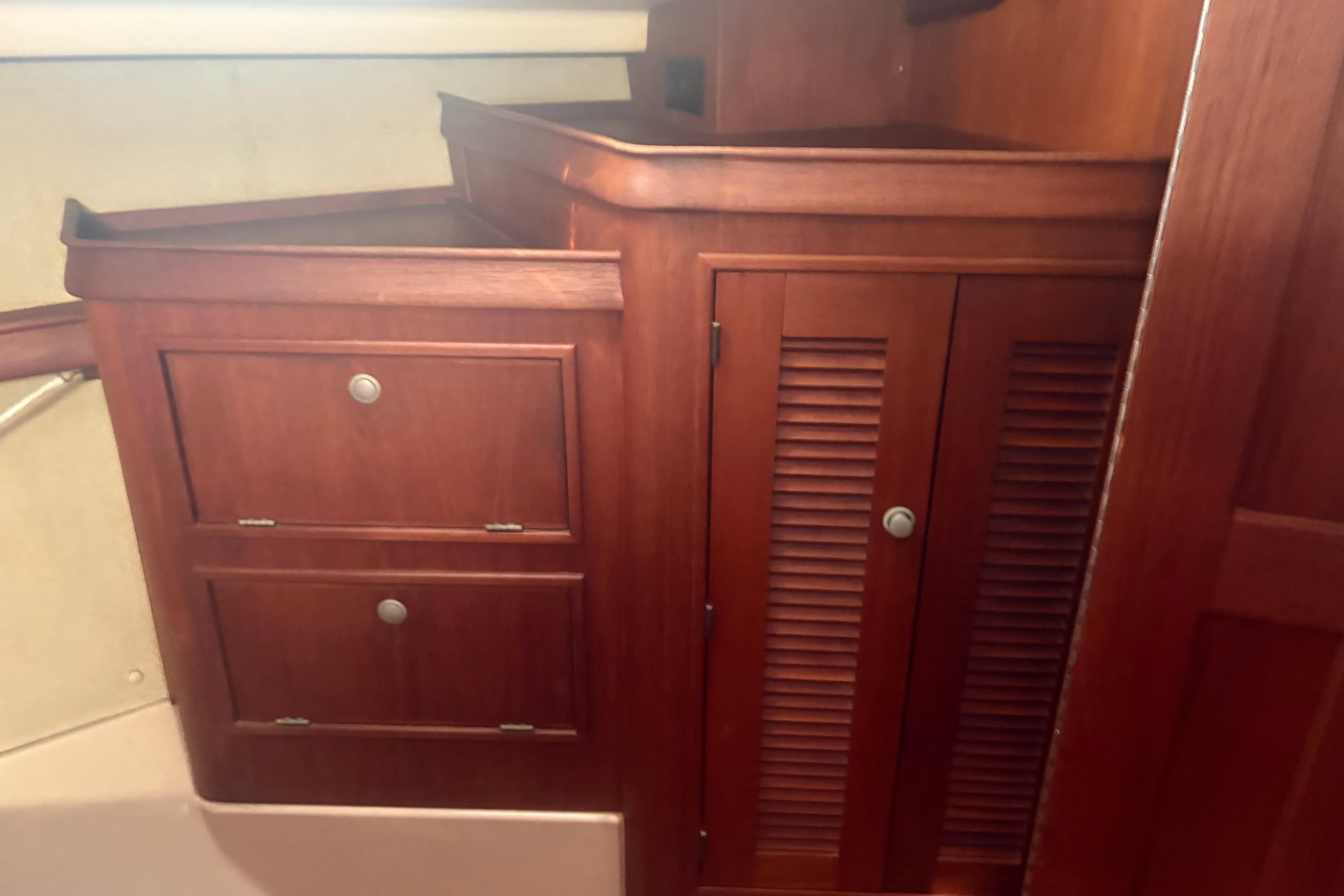 Interior of 1999 Island Packet 380 sailboat with wooden cabinetry and storage drawers.