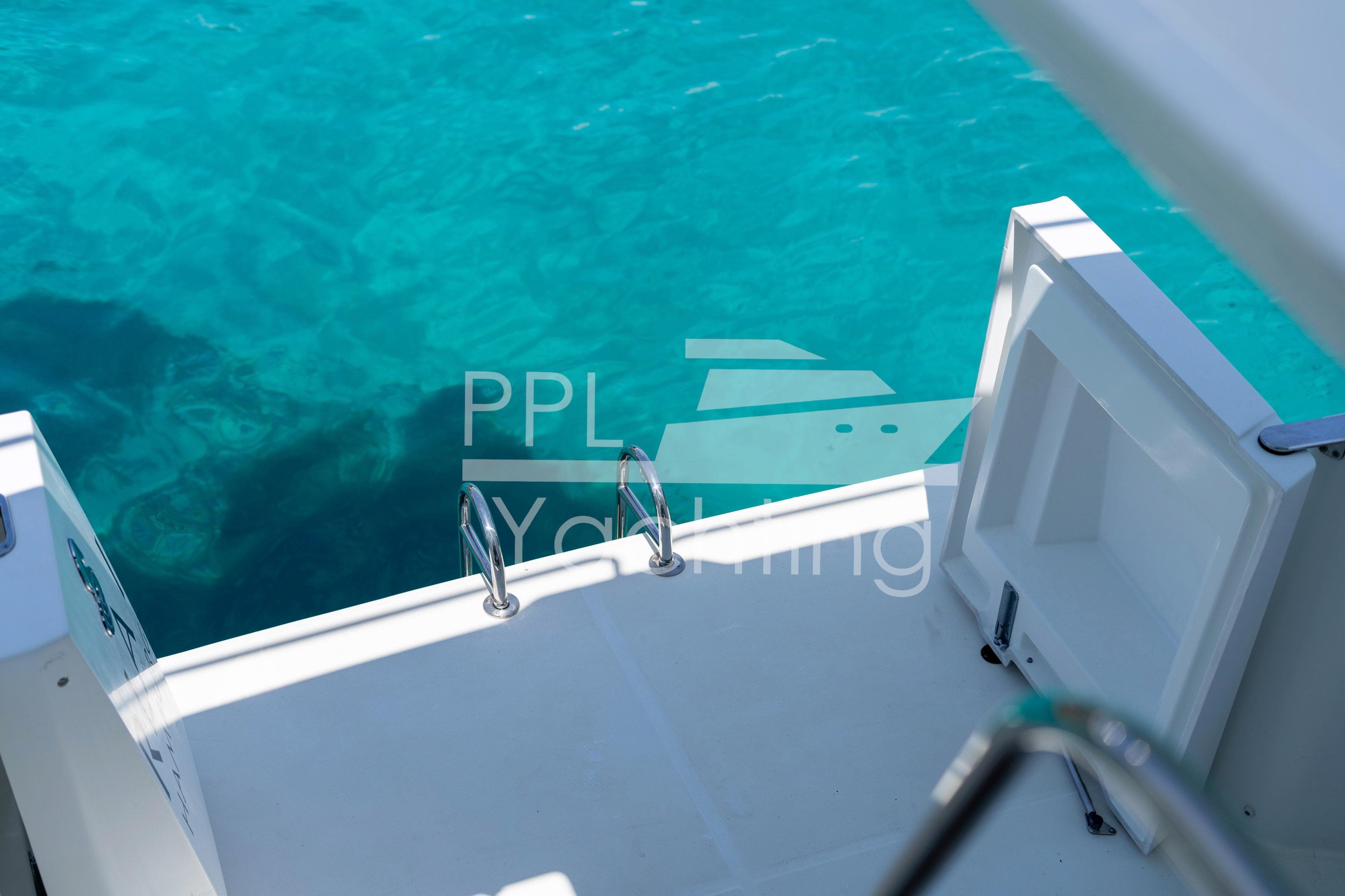 2019 Beneteau Swift Trawler 35 swim platform with ladder, turquoise water background.