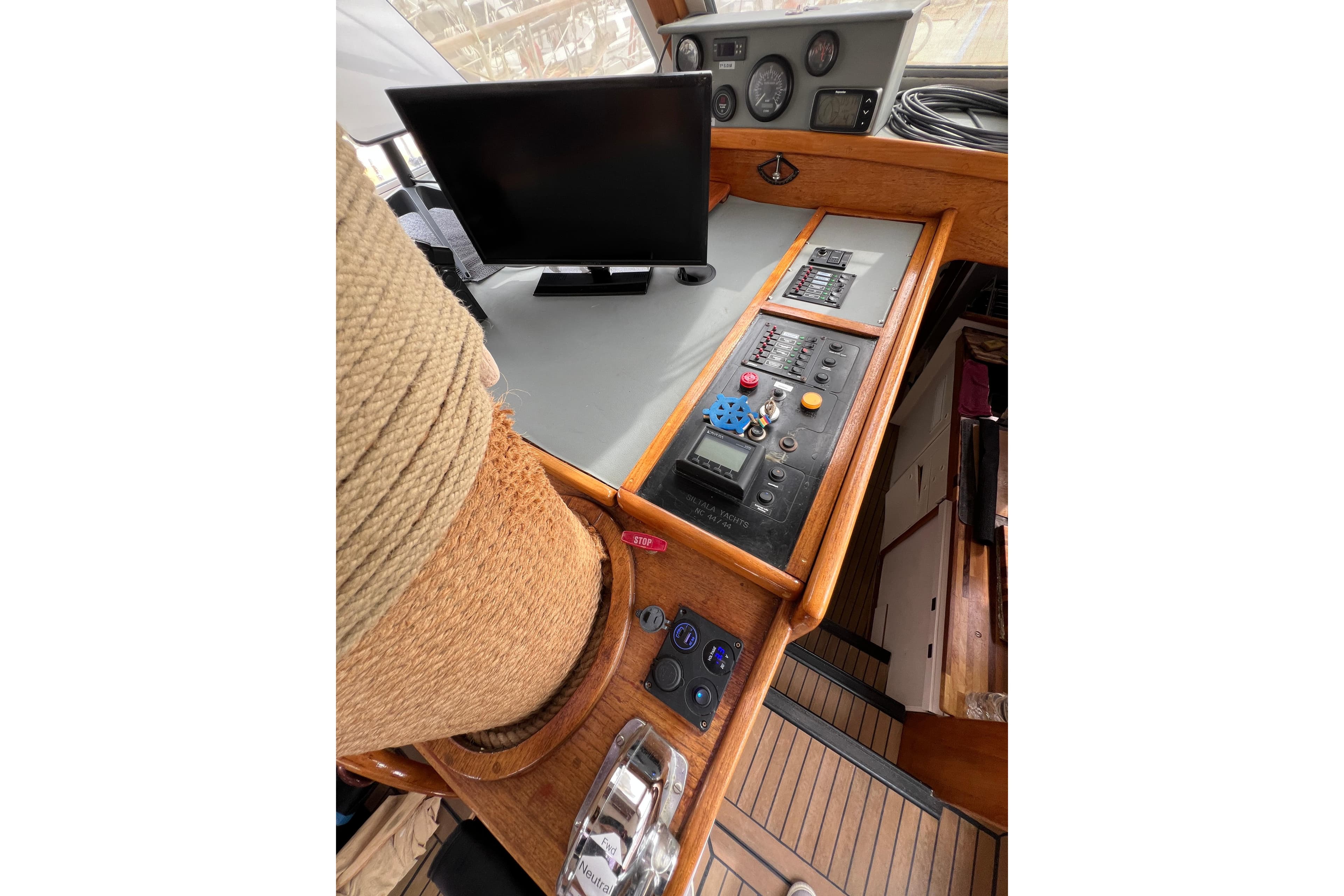 Control panel of a 1980 Nauticat 44 sailboat with navigation equipment and rope detail.