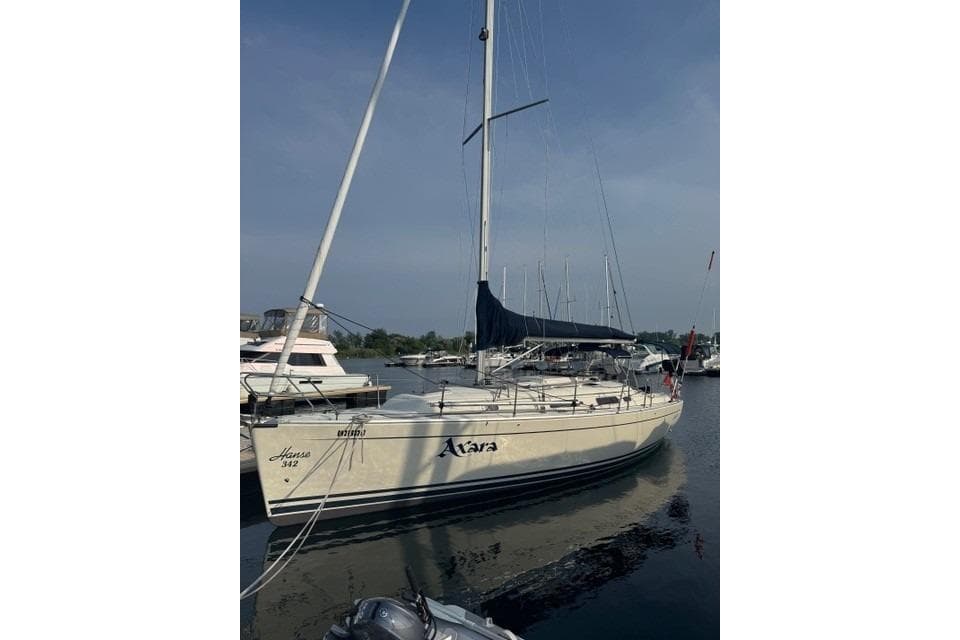 2005 Hanse 342 sailboat docked in a marina under clear skies.