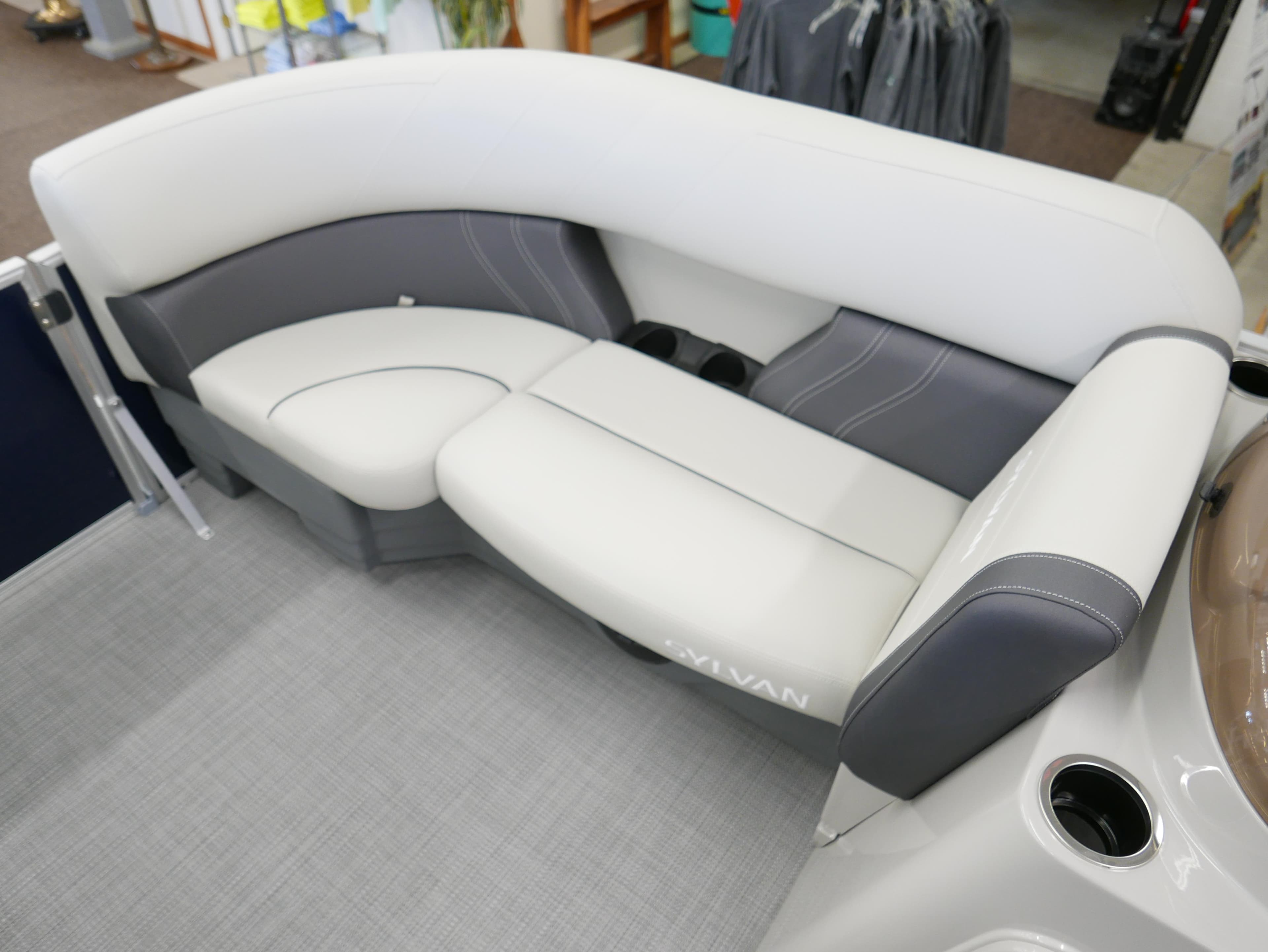 2025 Sylvan Mirage 8520 LZ boat interior with plush seating and cup holders.