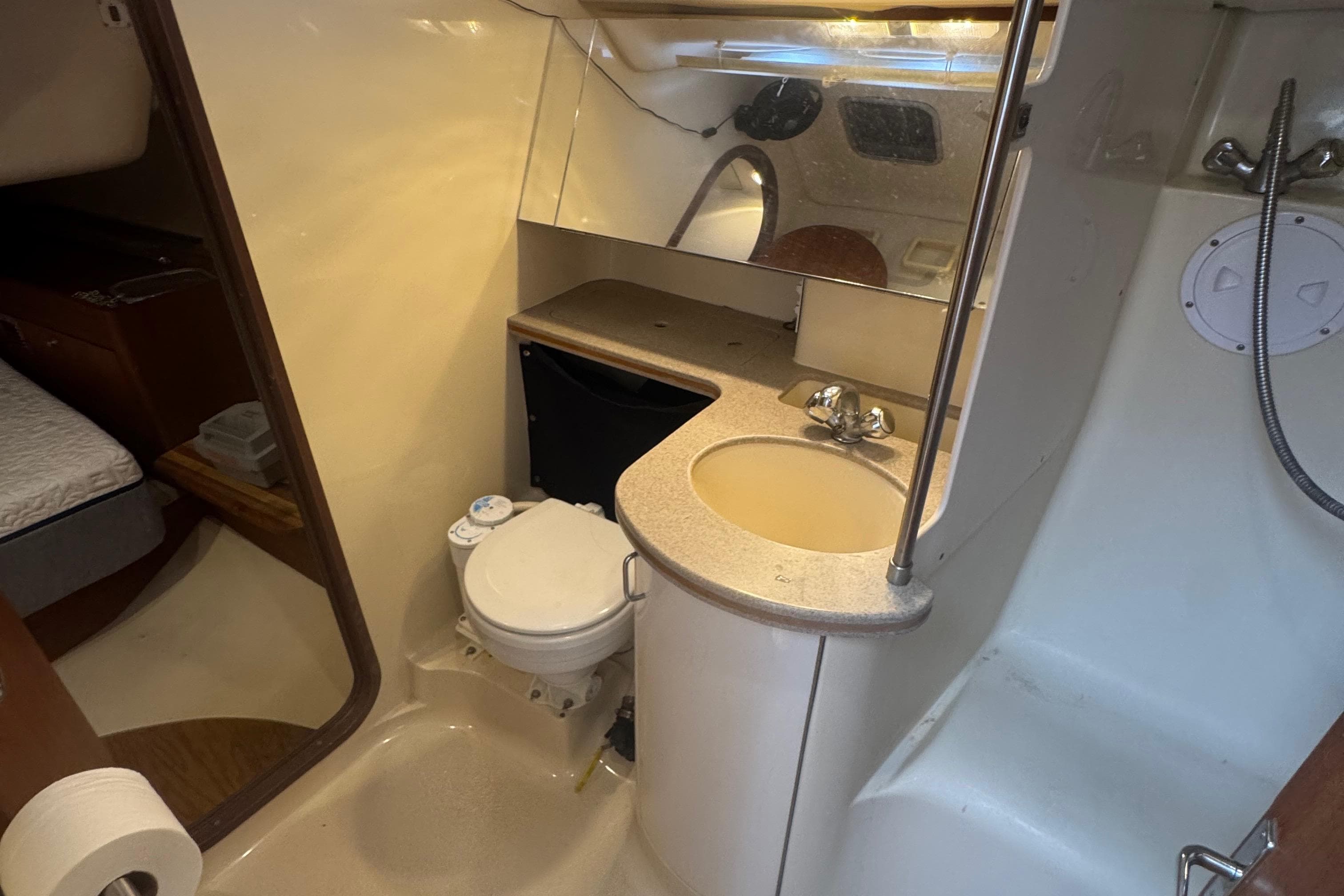 1998 Hunter 376 yacht bathroom with sink, toilet, and shower area.