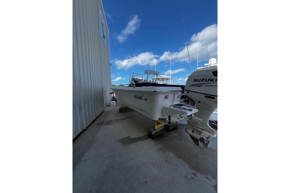 2017 Bulls Bay 2200 boat on trailer beside a building under a clear blue sky.
