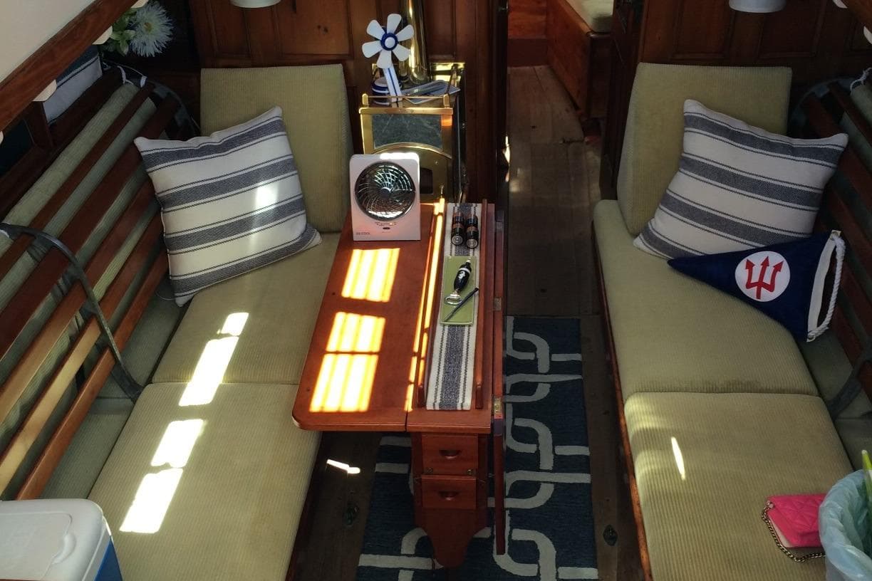 Interior of 1955 Concordia Yawl (Hull #33) with cozy seating and nautical decor.