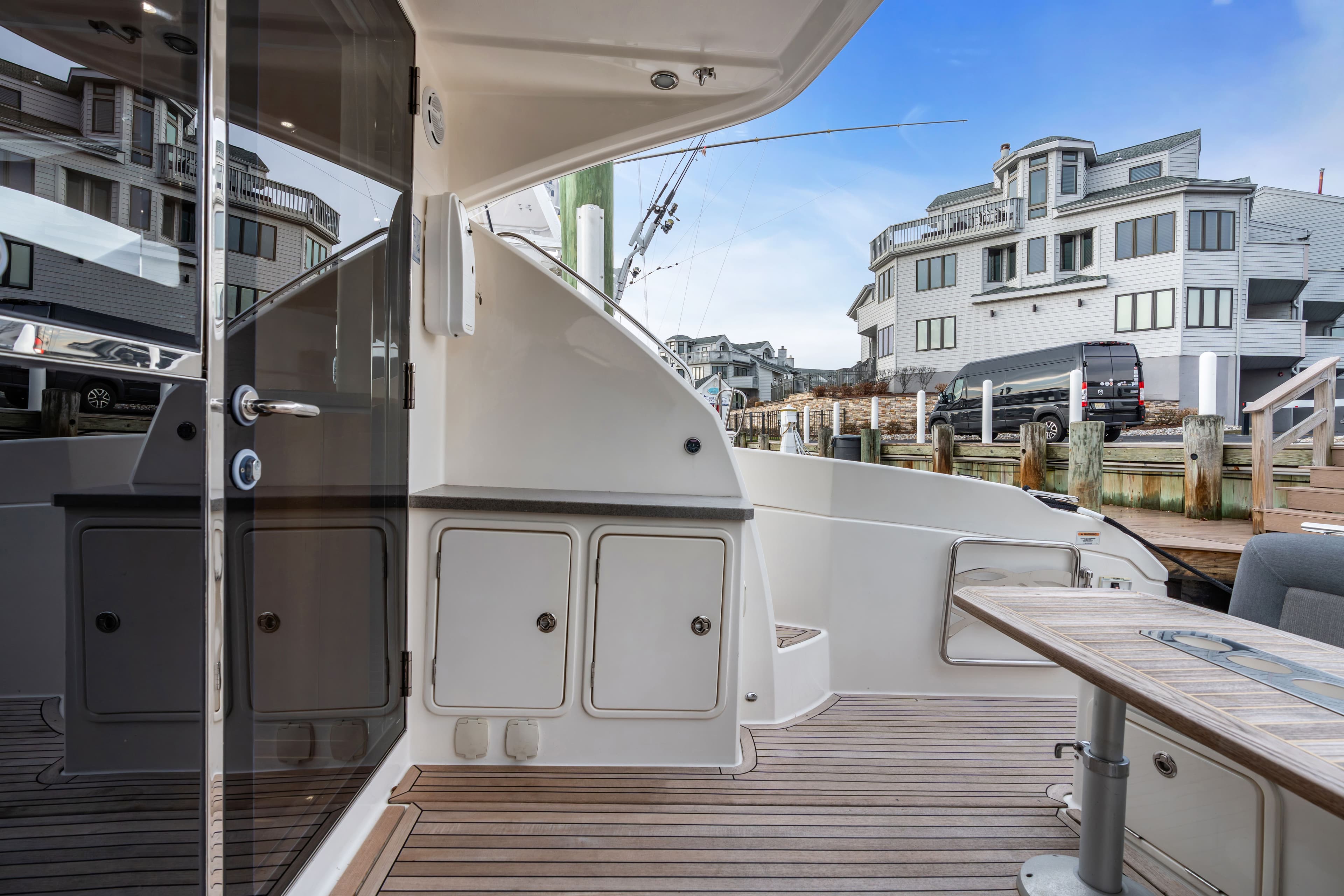 2014 Riviera 44 Sport Yacht docked with modern buildings in background.