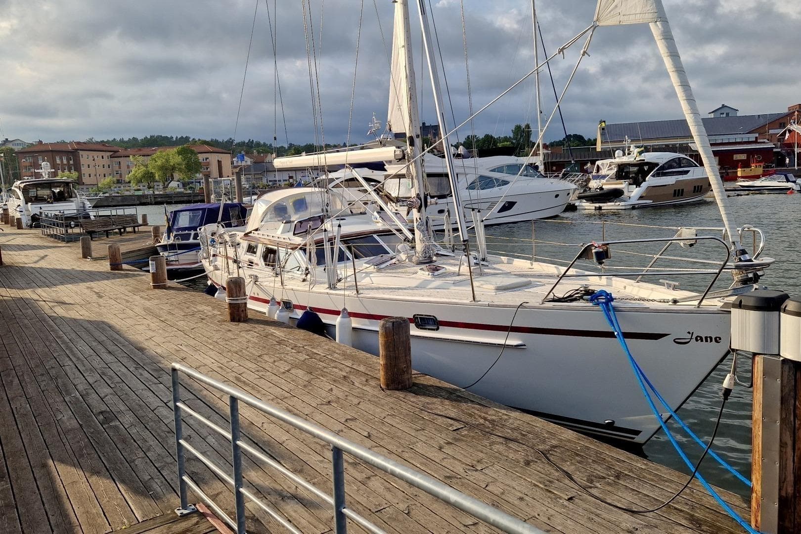 Sailboat Regina af Vindö 43 DS, 1999 model, docked at a marina with other boats.