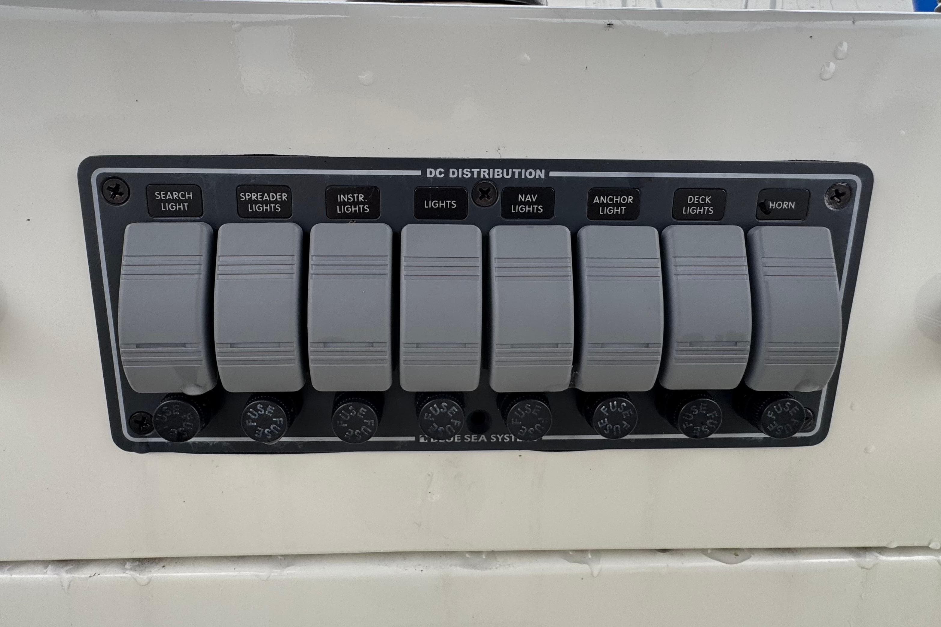 Control panel of a 1974 Tollycraft 40 Tri-Cabin MY with labeled switches for lights and horn.