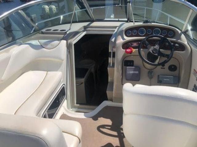Interior of 2003 Sea Ray 260 Sundancer boat with steering wheel and seating.