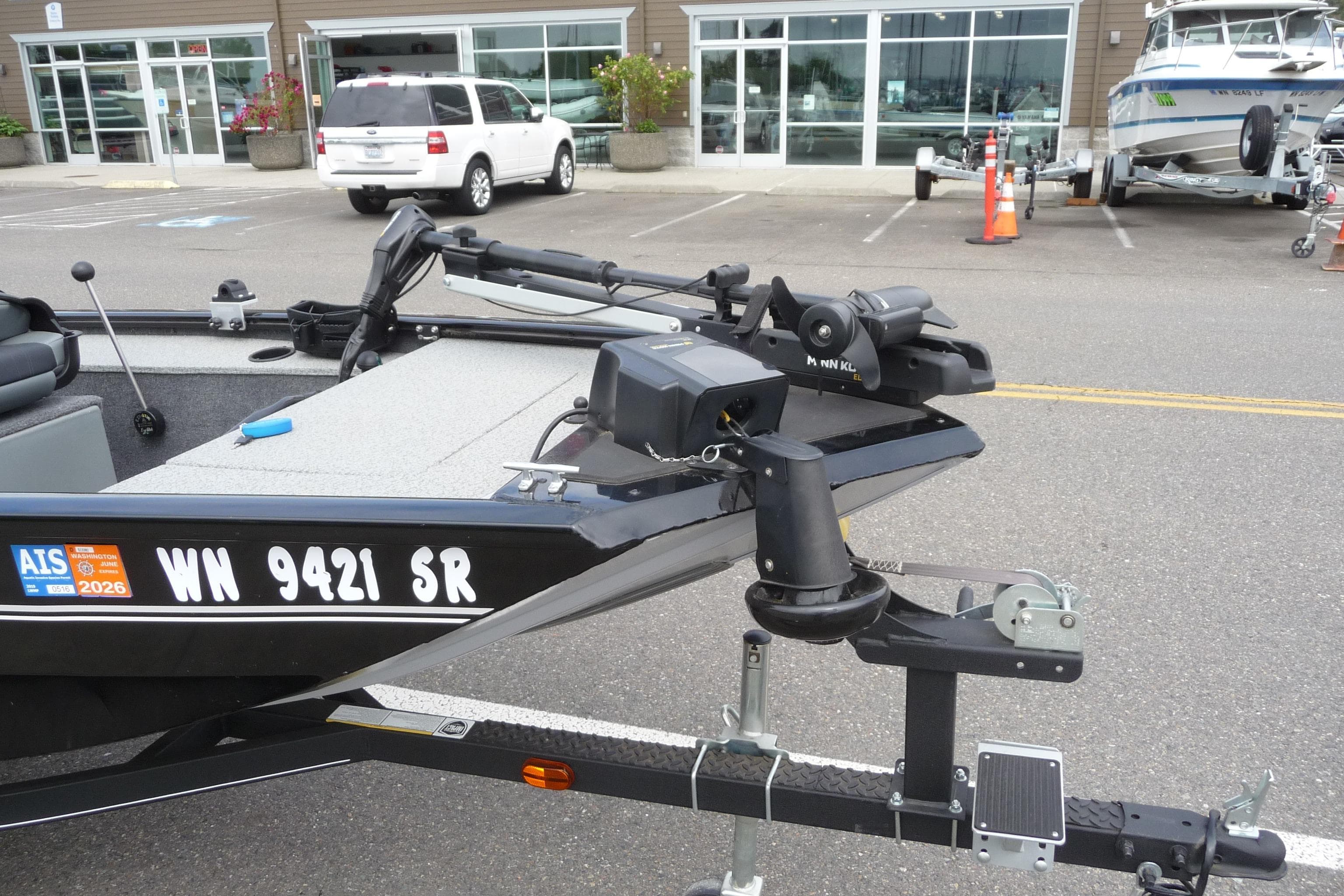 2019 Tracker Panfish 16 boat on trailer in parking lot, registration visible.
