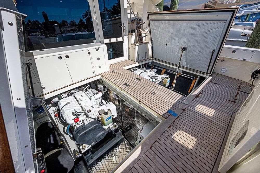 Engine compartment of a 2013 Mikelson Luxury Sportfisher, showcasing detailed mechanical components.